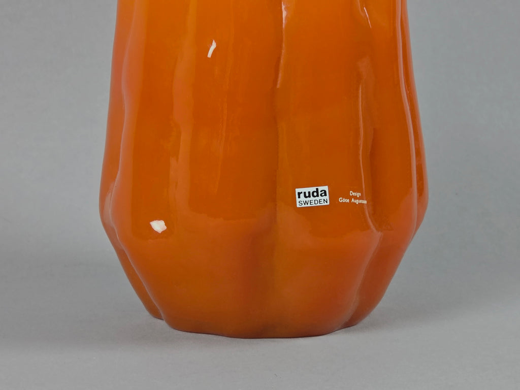 1960s vintage Ruda Glasbruk Selena vase by Gote Augustsson in orange and yellow hue, photo showing the texture of the orange ceramic and the shiny surface.