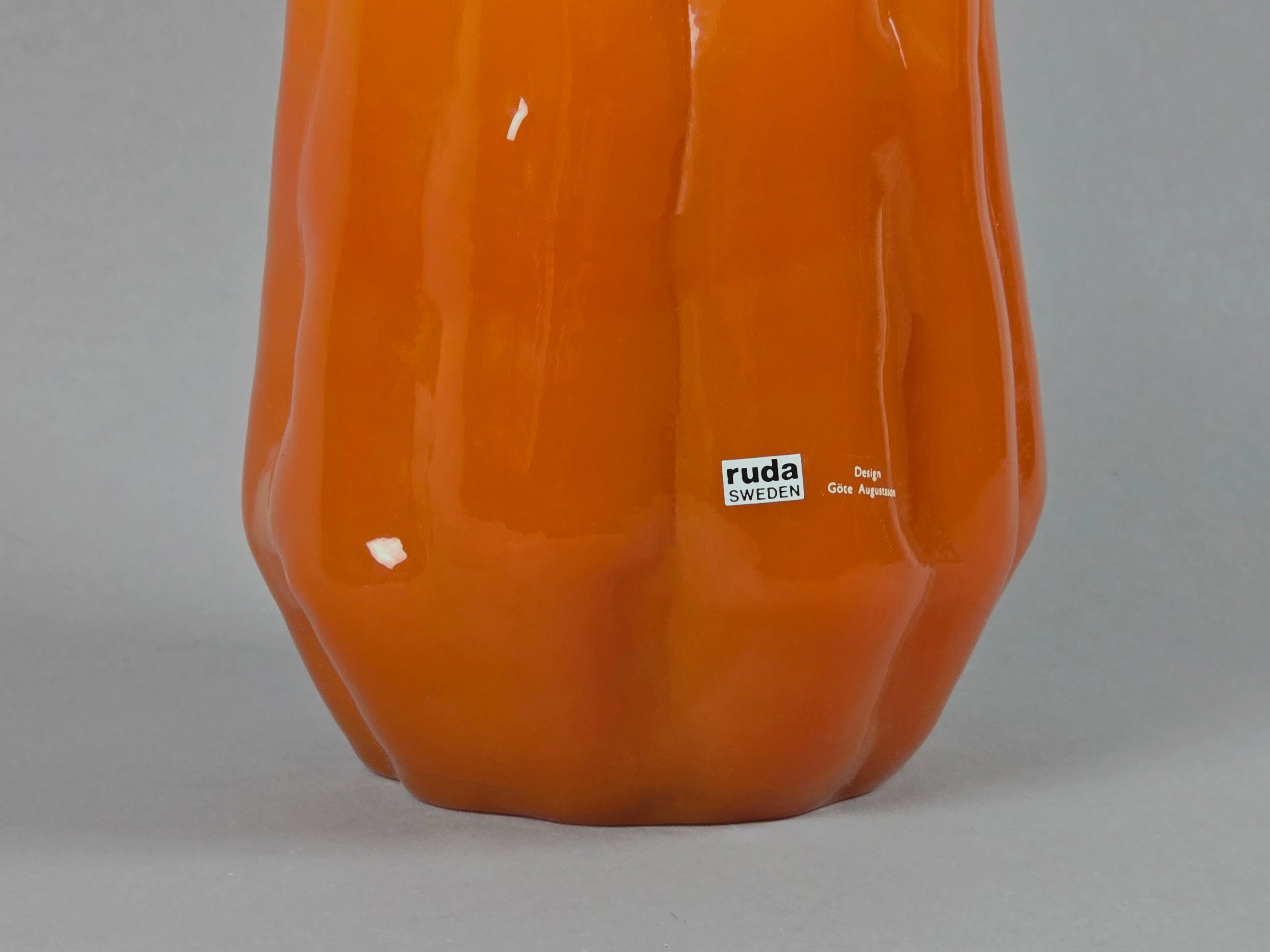 1960s vintage Ruda Glasbruk Selena vase by Gote Augustsson in orange and yellow hue, photo showing the texture of the orange ceramic and the shiny surface.
