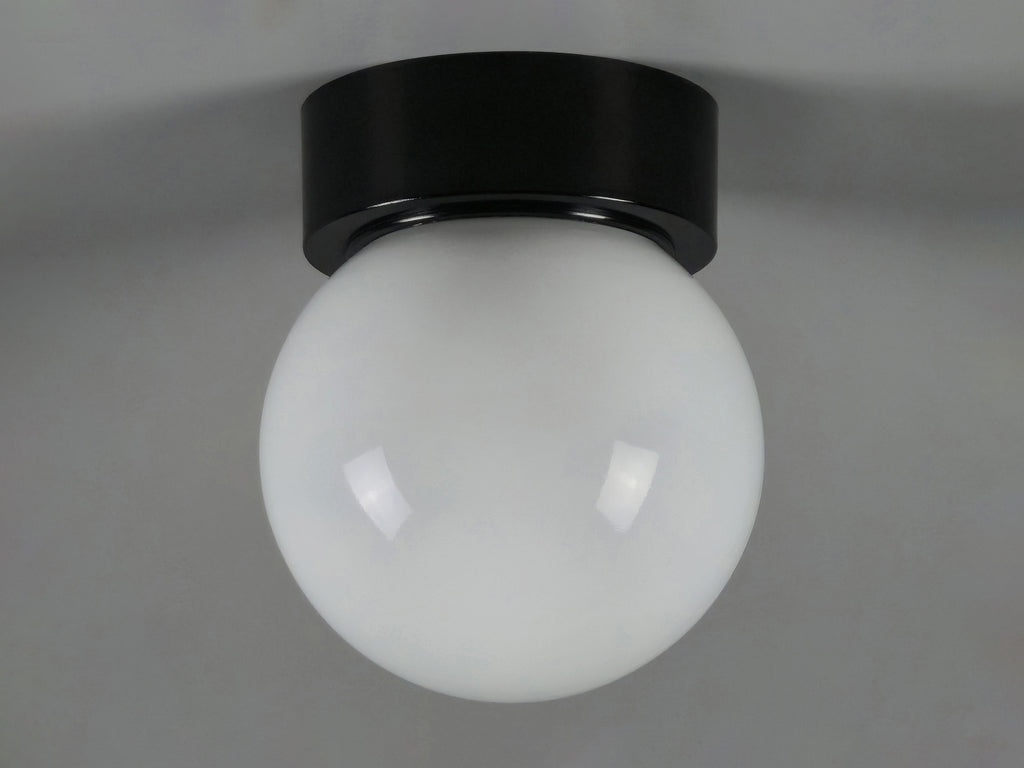 1960s vintage MCM globe glass light fixture by Corodex Holland, showing slightly angled profile, ceiling mounted.