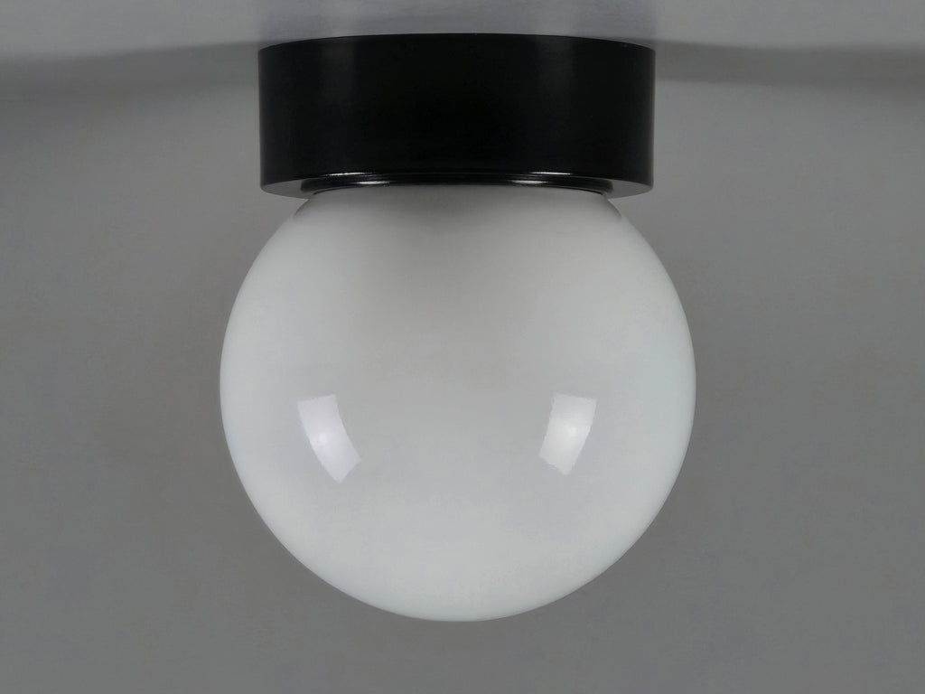 1960s vintage MCM globe glass light fixture by Corodex Holland, showing the profile, ceiling mounted with a neutral light grey background.