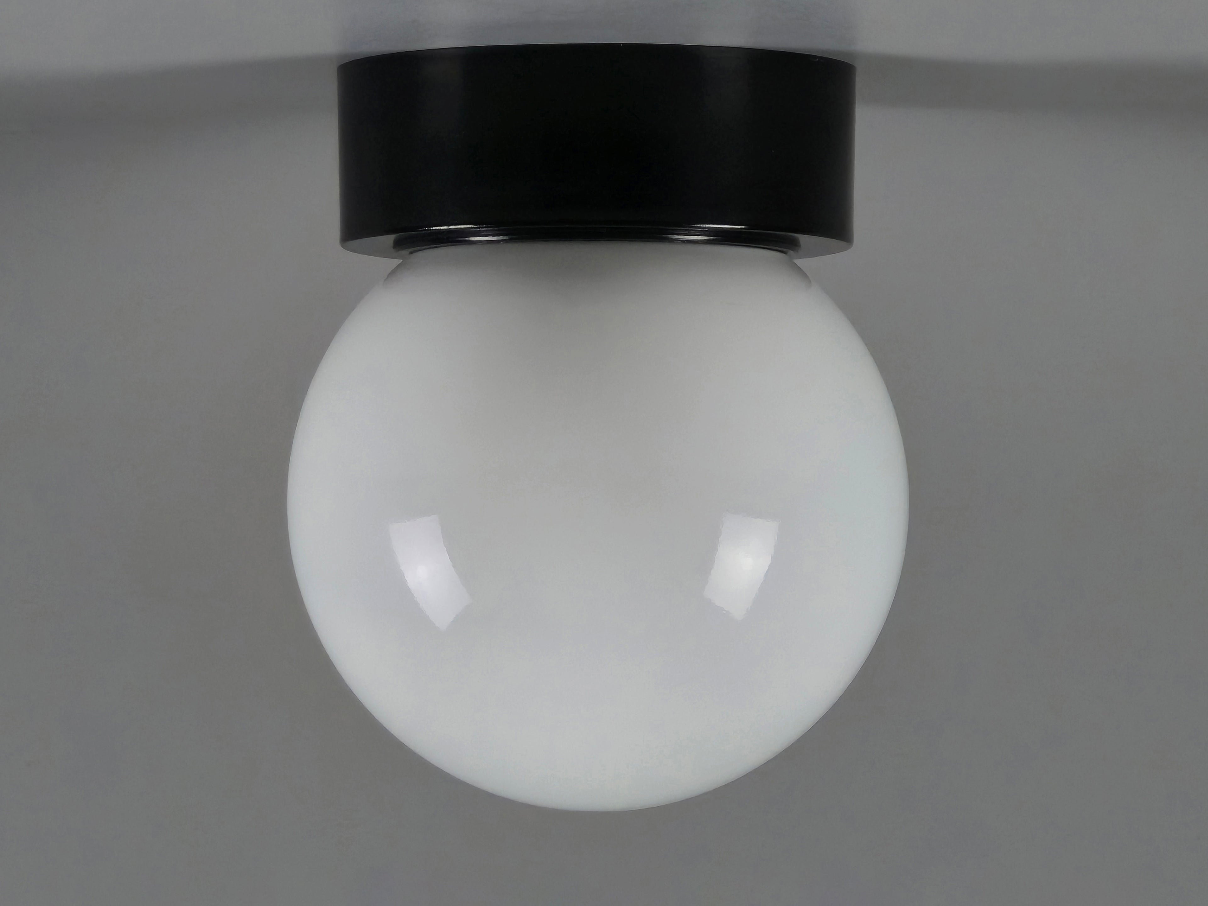 1960s vintage MCM globe glass light fixture by Corodex Holland, showing the profile, ceiling mounted with a neutral light grey background.