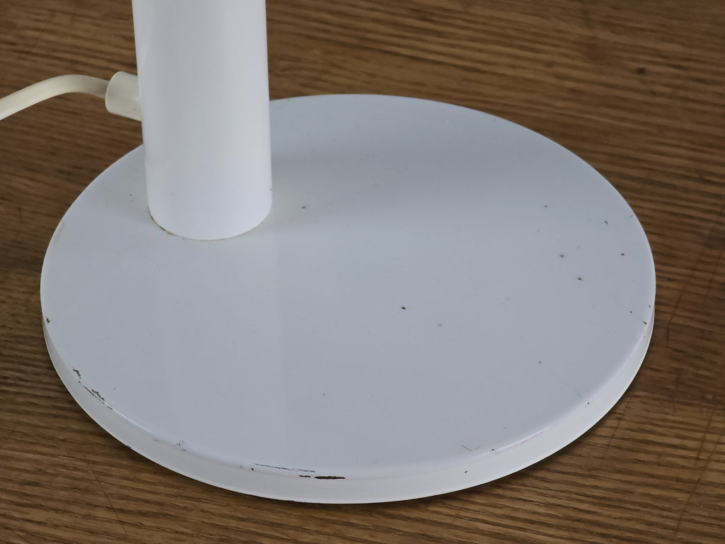 1960s Mid Century Modern gooseneck desk lamp by Hala Zeist, macro shot of the round weighted base, showing the metal texture and the minor scuffs and age related wear.