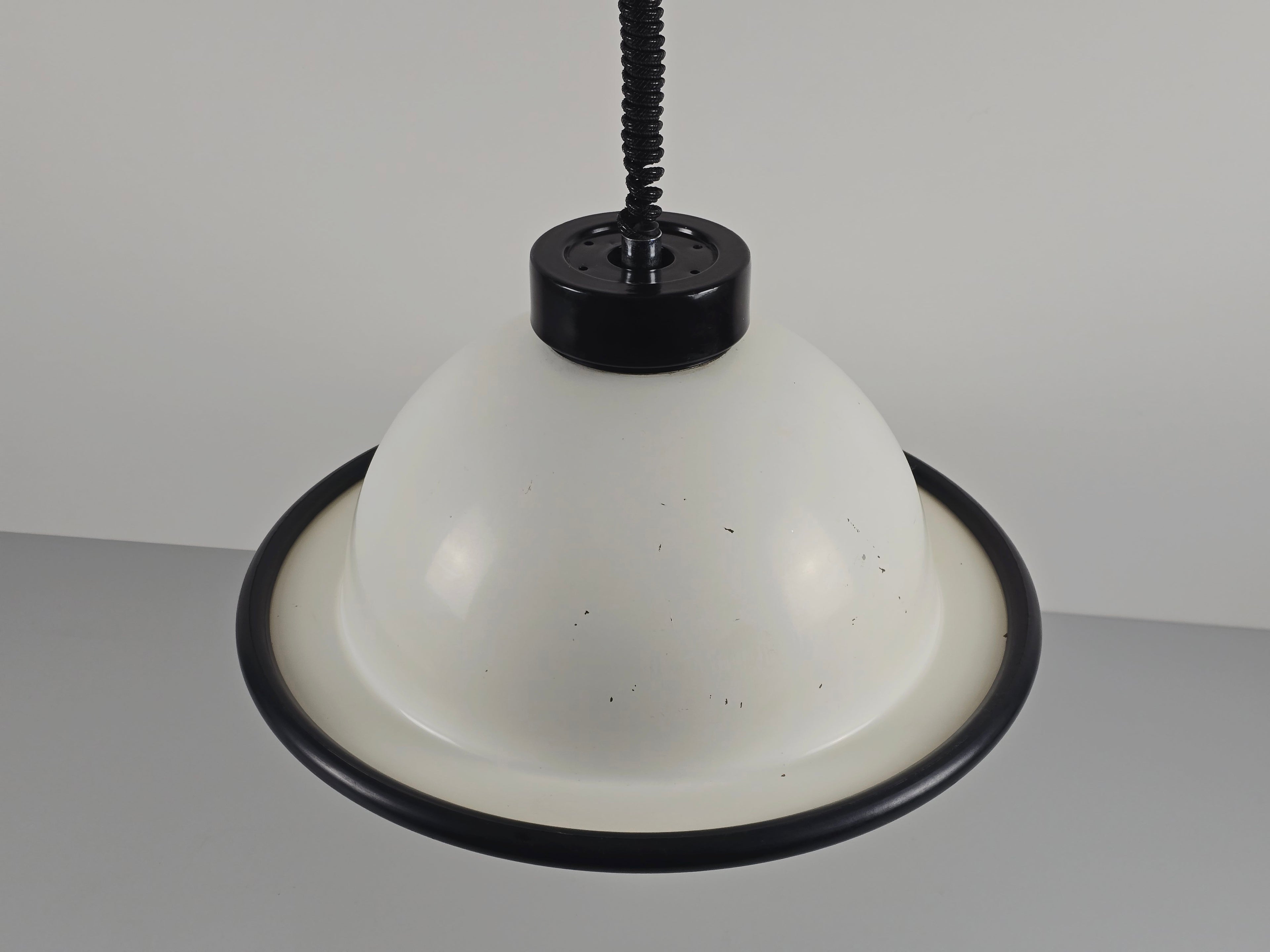 A high-angle perspective looking down at the top of the vintage 1960s MCM Martinelli Luce rise & fall pendant lamp by Elio Martinelli.