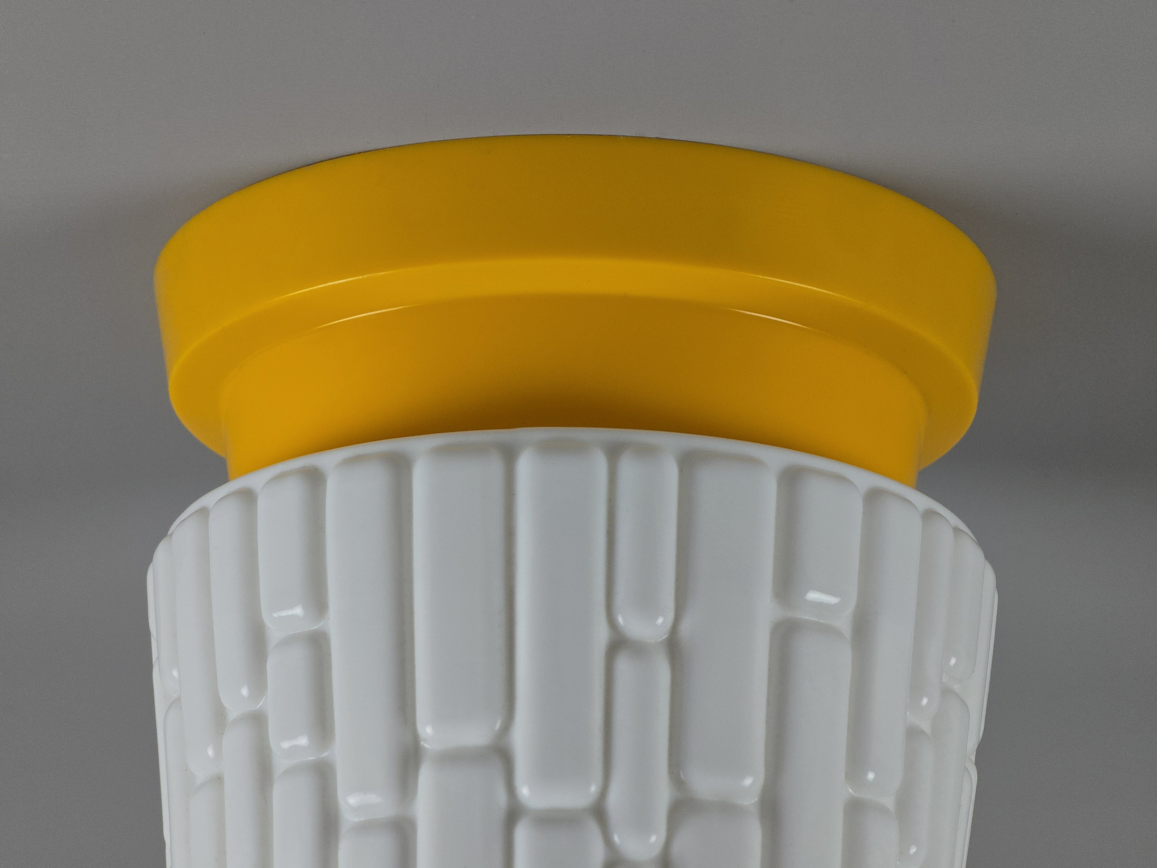 close up image of a yellow plastic base for a vintage light fixture