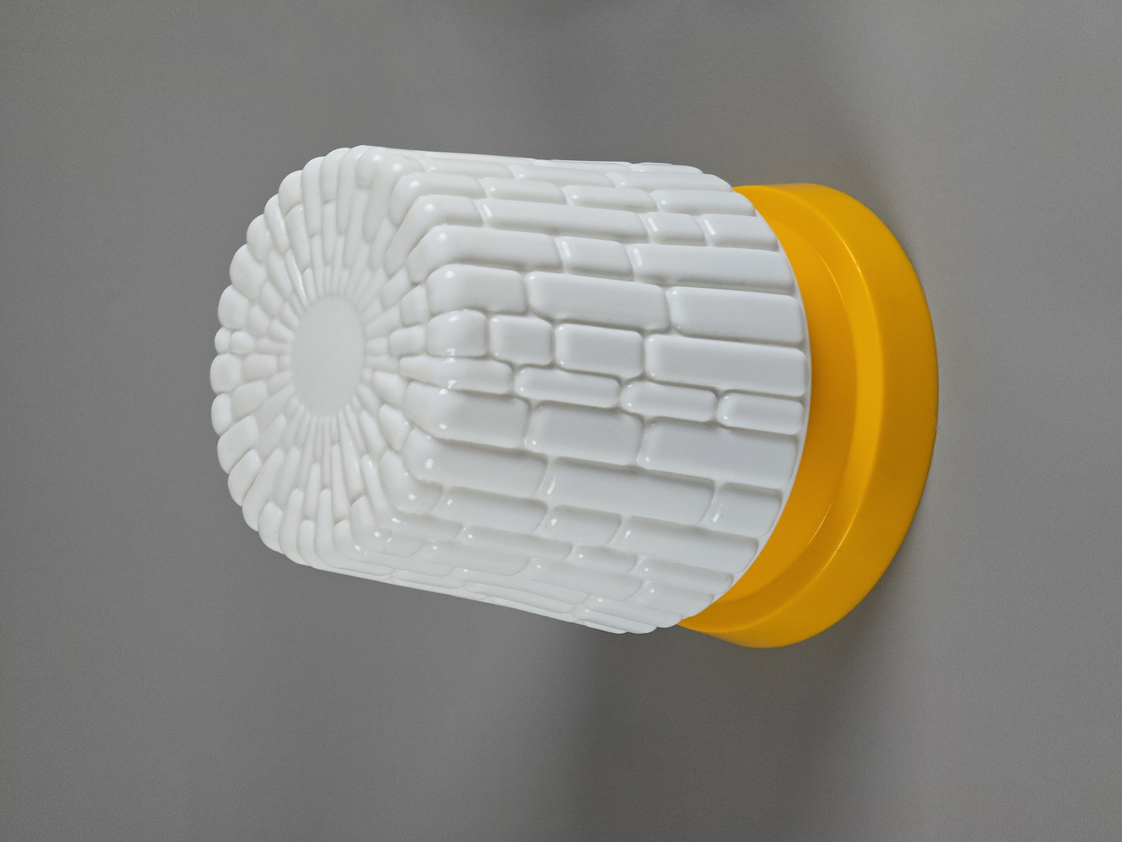MCM wall sconce with opalware textured glass and yellow base from the 1970s