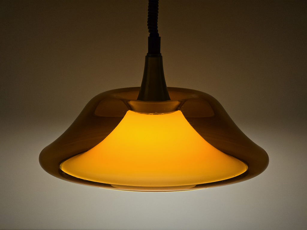 Atmospheric shot of the amber lamp lit in a dim setting, demonstrating its warm ambient light quality.