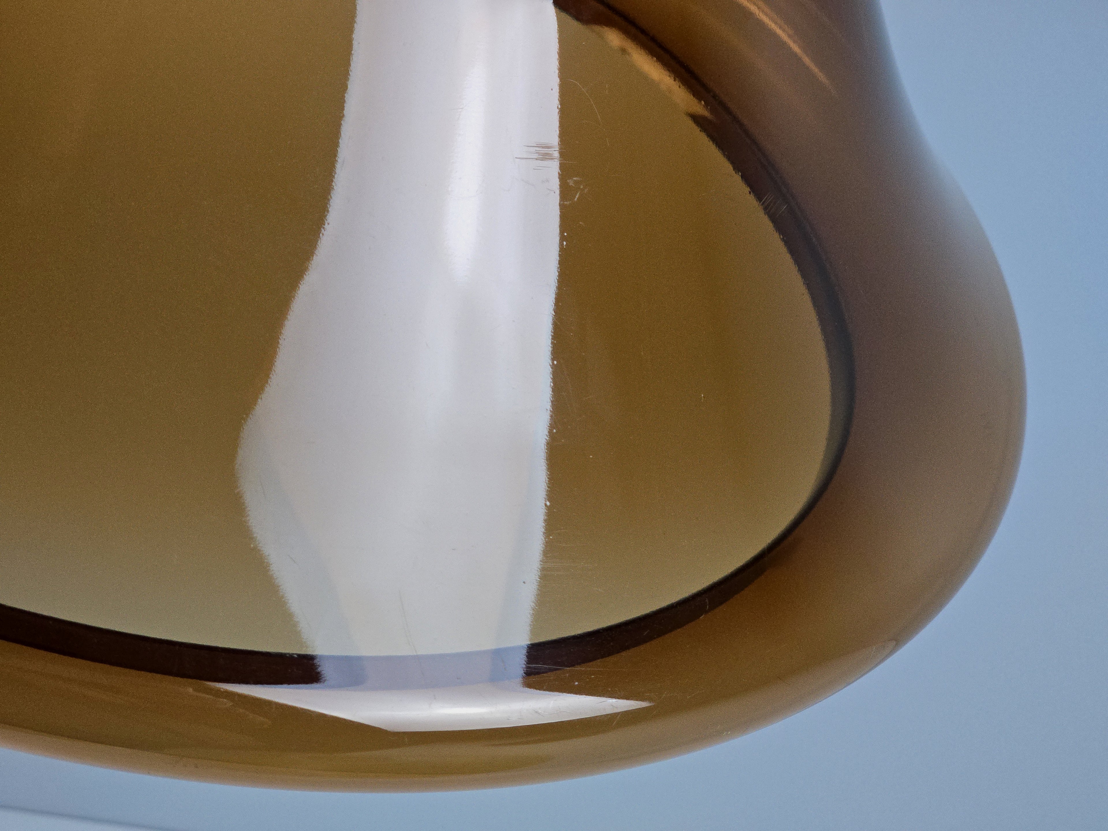 Close-up of the translucent amber material under direct light, showcasing the clarity and color saturation.