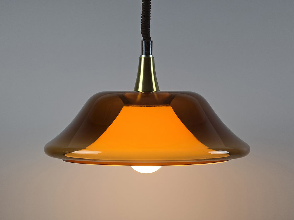 Full view of a retro amber pull-down lamp against a neutral background, highlighting the iconic UFO silhouette.