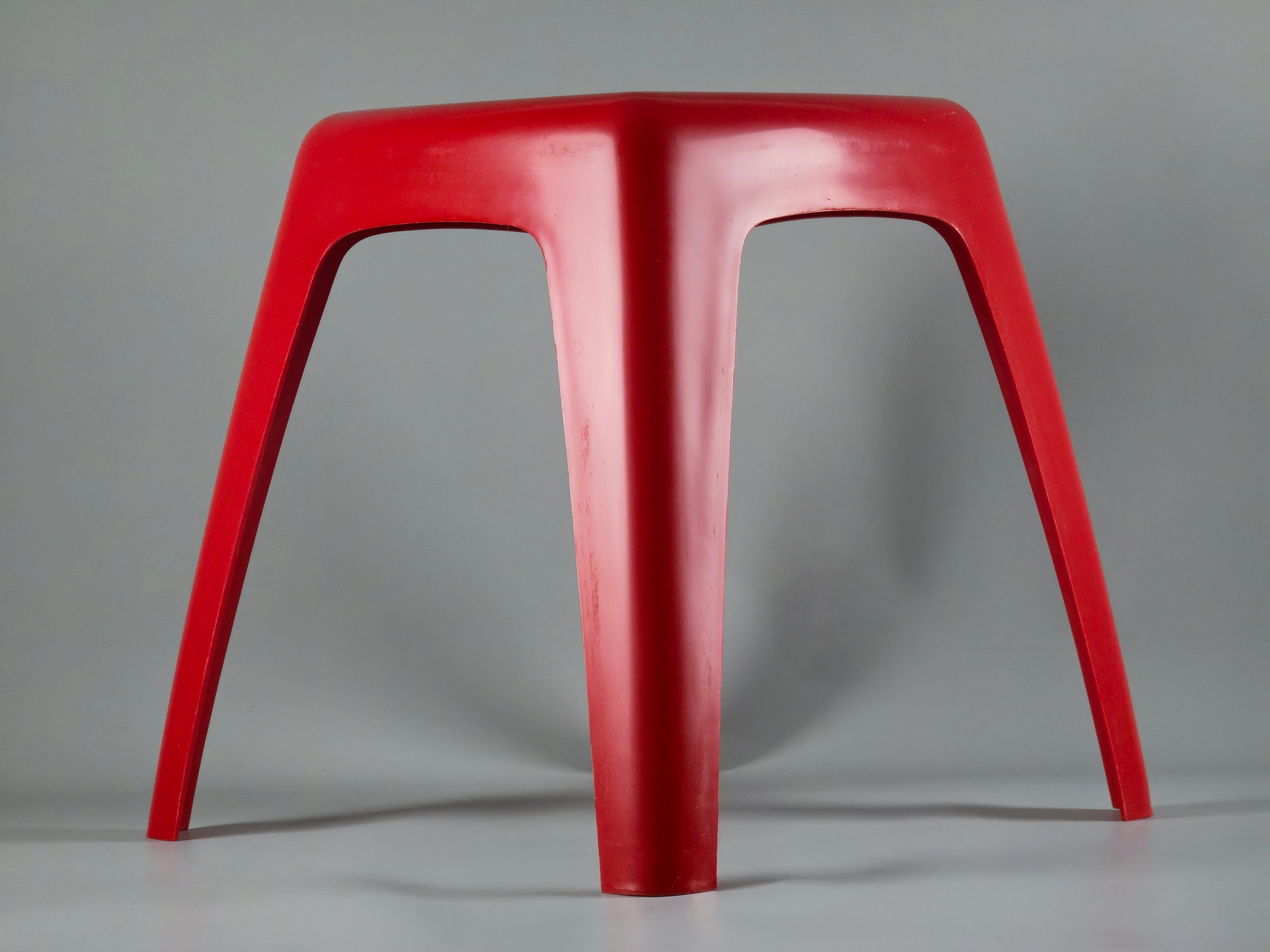Side profile view highlighting the curved, organic geometry of the stool. The design features a wider base with a subtly tapered middle section and narrower top, typical of 70s Dutch modernism.