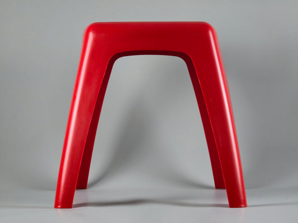Side profile view highlighting the curved, organic geometry of the stool. The design features a wider base with a subtly tapered middle section and narrower top, typical of 70s Dutch modernism.