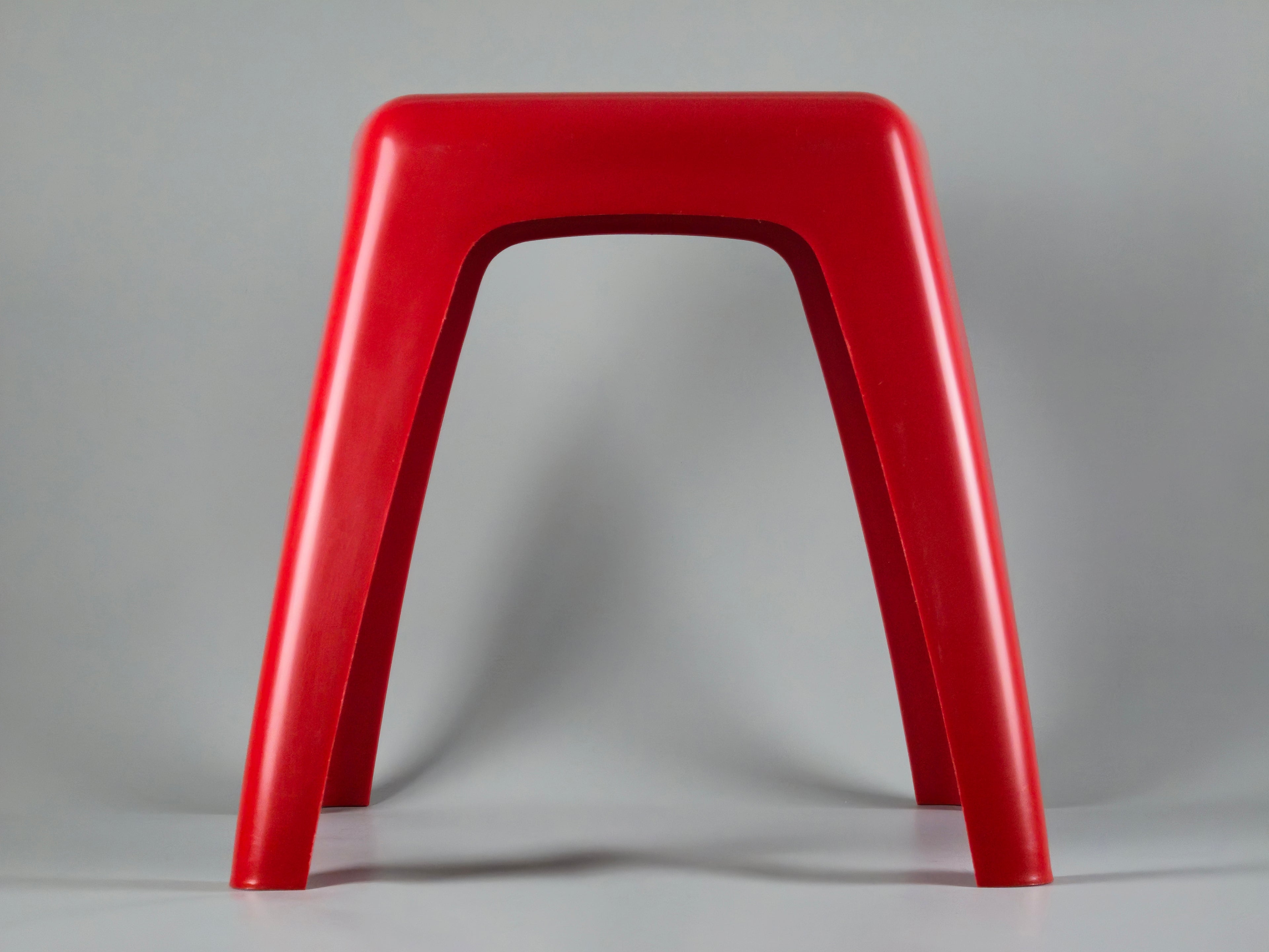 Side profile view highlighting the curved, organic geometry of the stool. The design features a wider base with a subtly tapered middle section and narrower top, typical of 70s Dutch modernism.