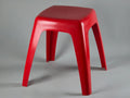 Vibrant red 1970s plastic stool by Flair Holland. Smooth, glossy hourglass shape with a minimalist Space Age silhouette. Shown from the front against a clean, neutral background.