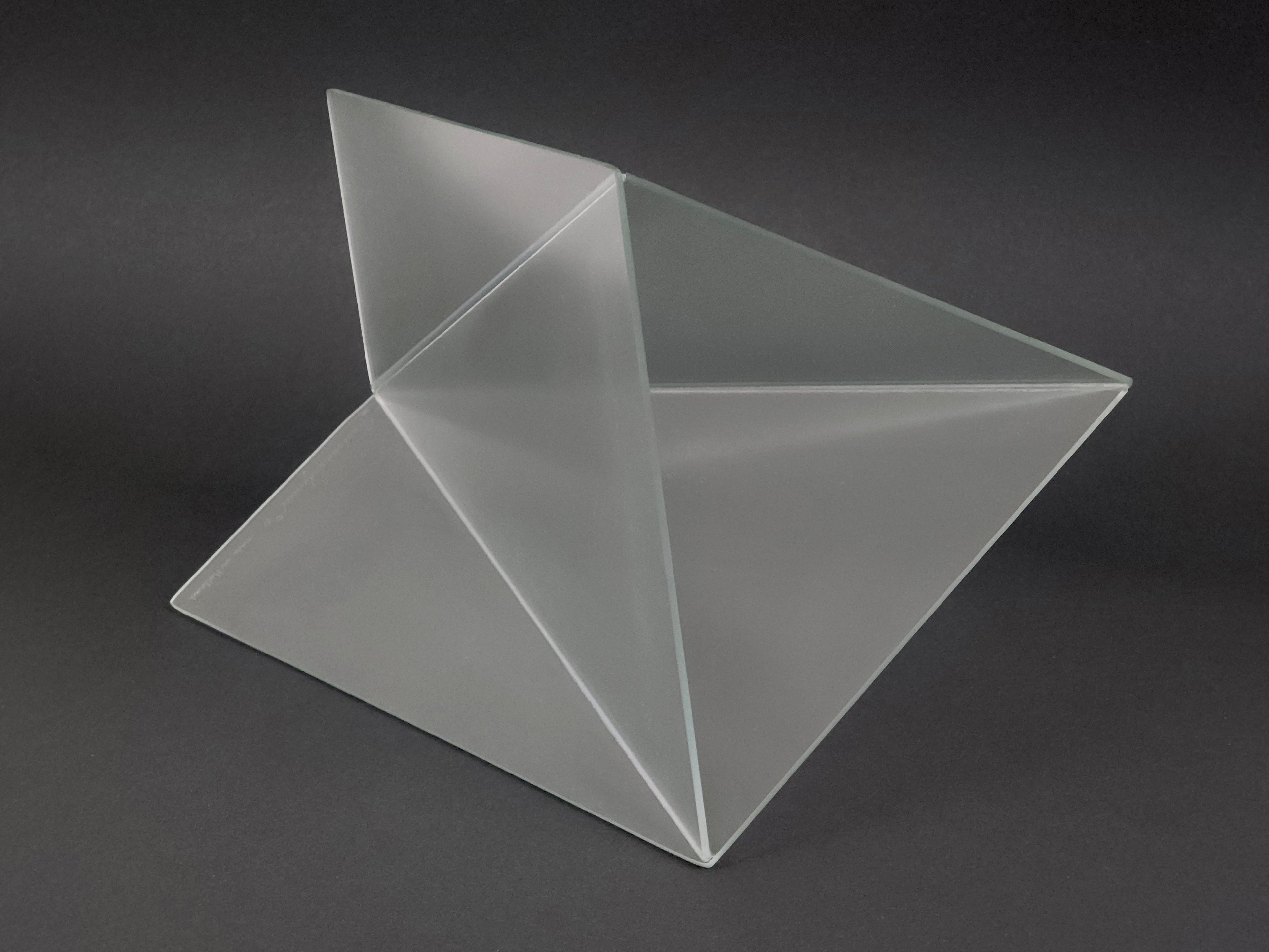 1981 Mart van Schijndel Delta vase, Dutch postmodern design iconic frosted glass vase, the vase here is on it's side showing another angle for the viewer to get a good grasp of the volumes. The background is dark which shows the cleanliness of the frosted glass.