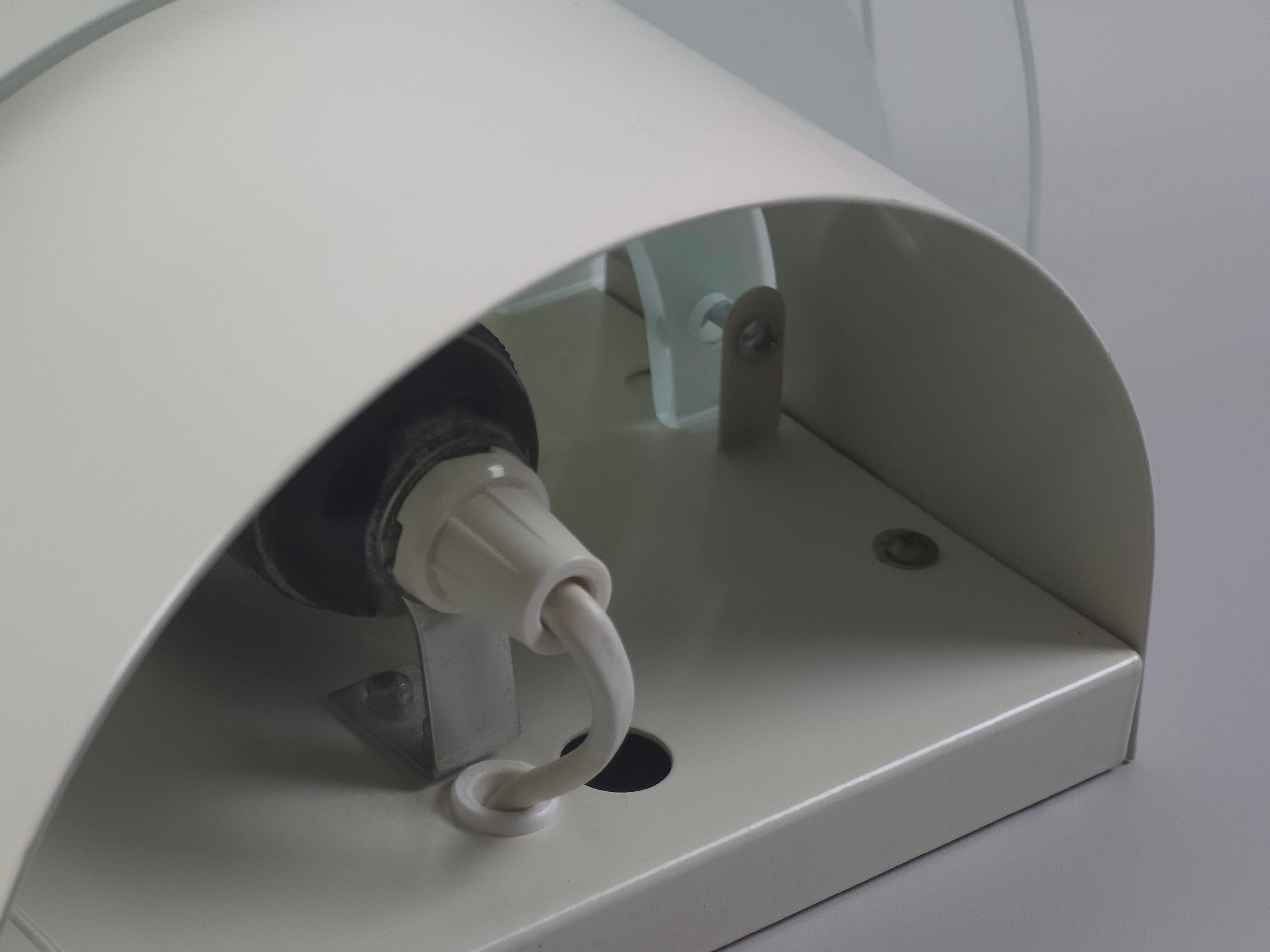 Interior detail of the IKEA Drittel lamp featuring the original ceramic socket and electrical wiring for global use.