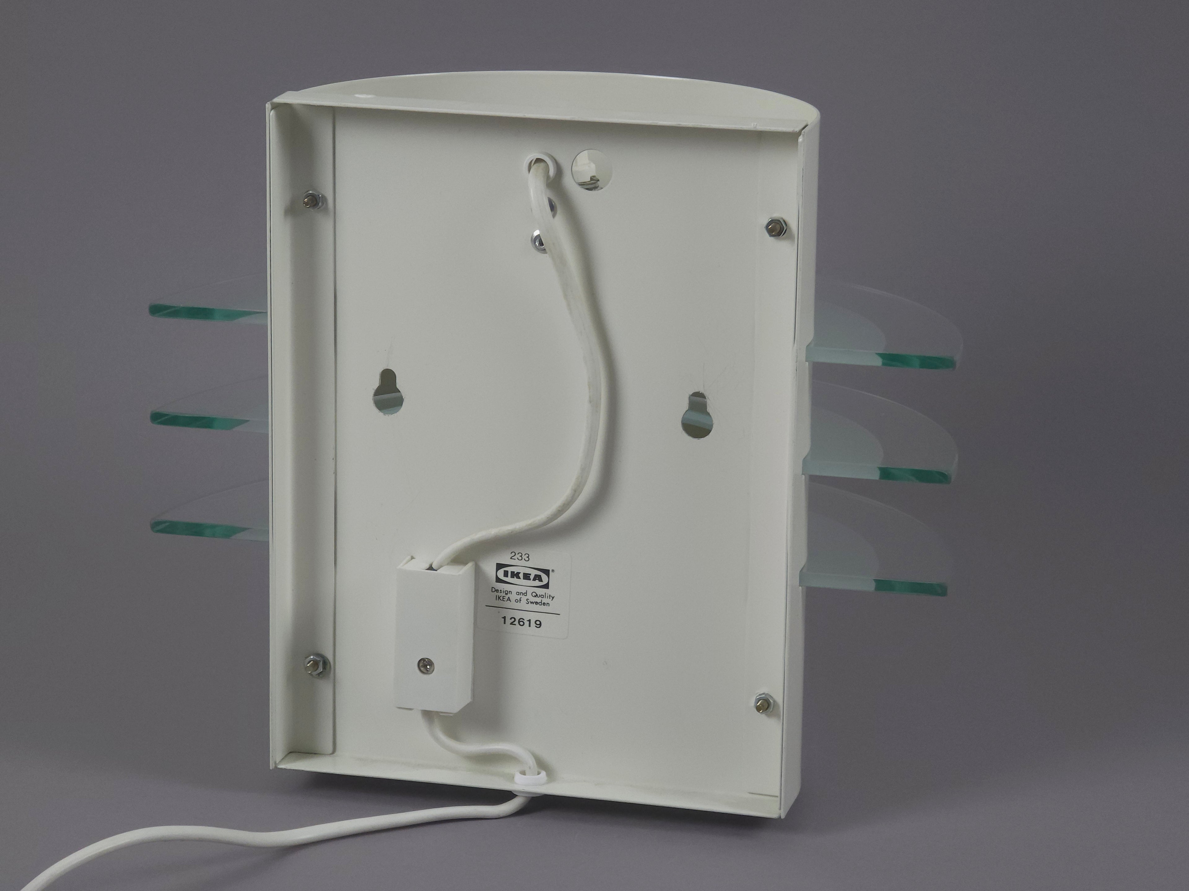 Back view of the IKEA Drittel wall lamp showing the original metal bracket for direct wall-point installation.