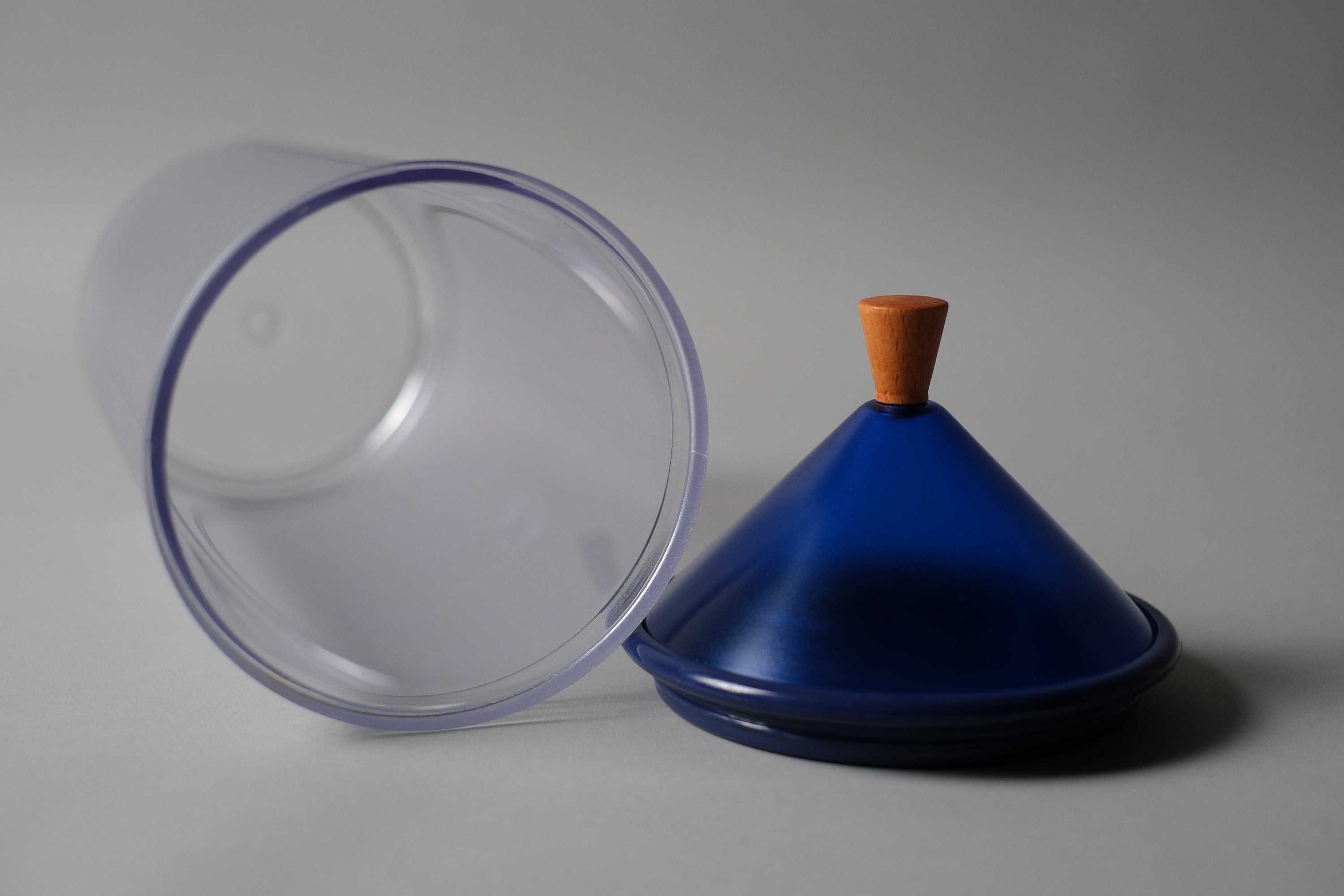 Close up image of the Biesse jar, showing inside the cylindrical container and the blue cone lid.