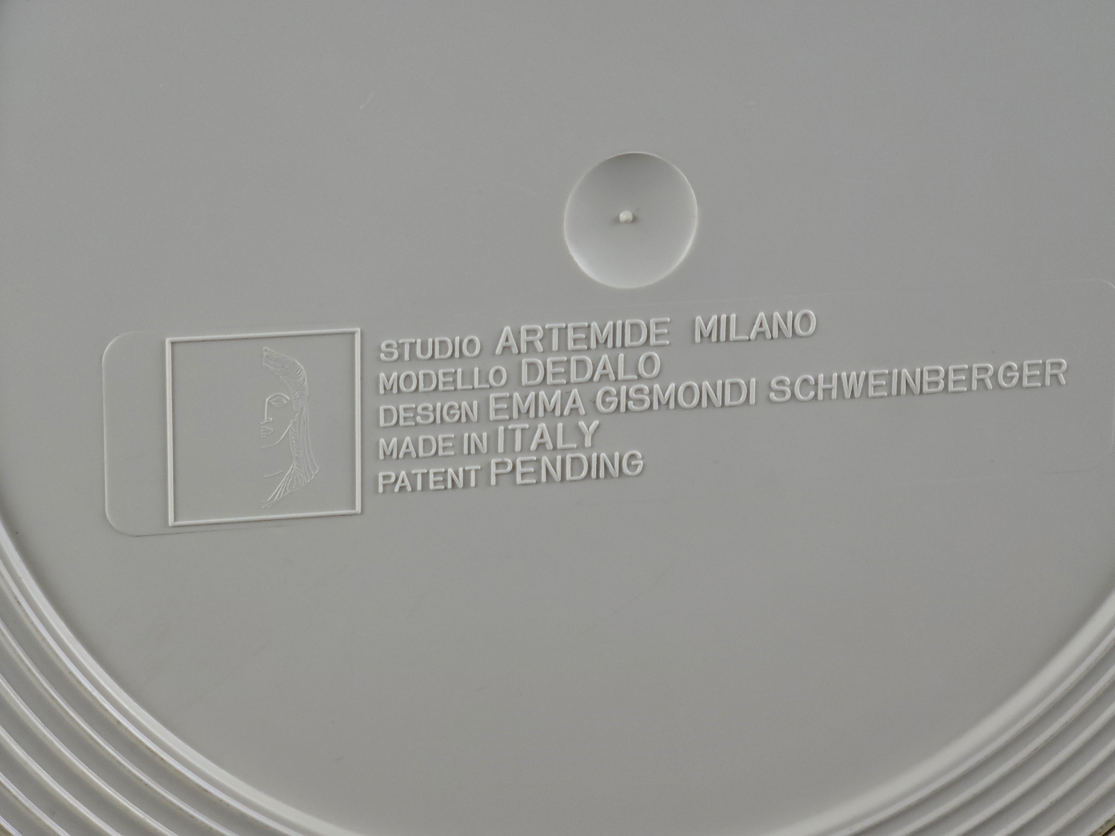 Close-up of the manufacturer's mark 'Artemide Milano Made in Italy' on the plastic base.