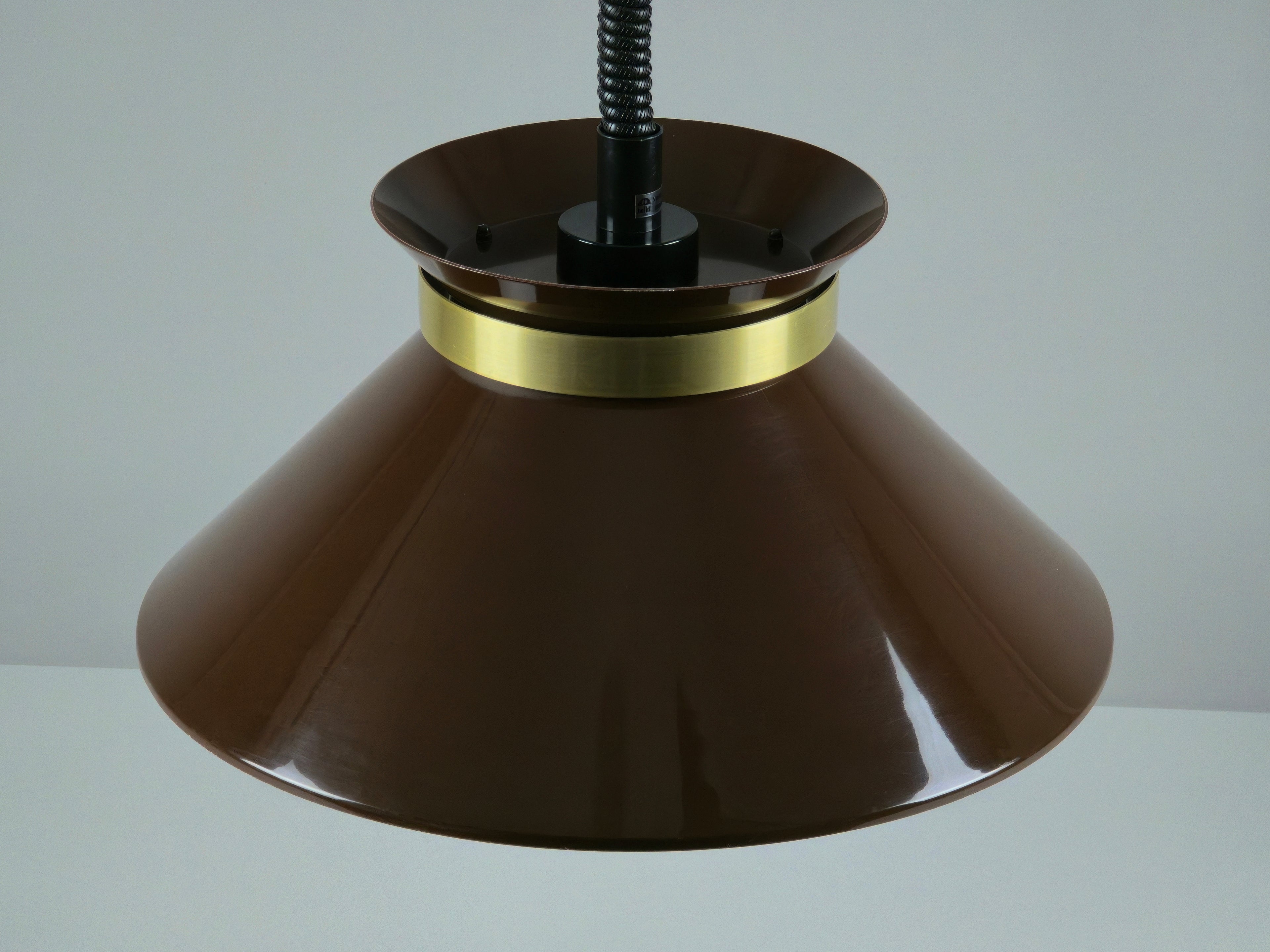 Top down view brown lacquered metal shade on Belid pendant light with brass ring.