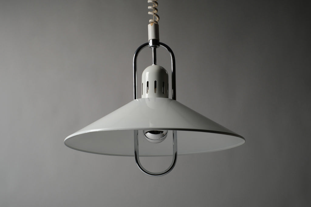 Low-angle front view of a 1980s Belid T127 pendant lamp attributed to Jan Eskil Eskilsson, showing the broad arched saucer form and original ceiling cap with coiled rise-and-fall cord, Sweden.
