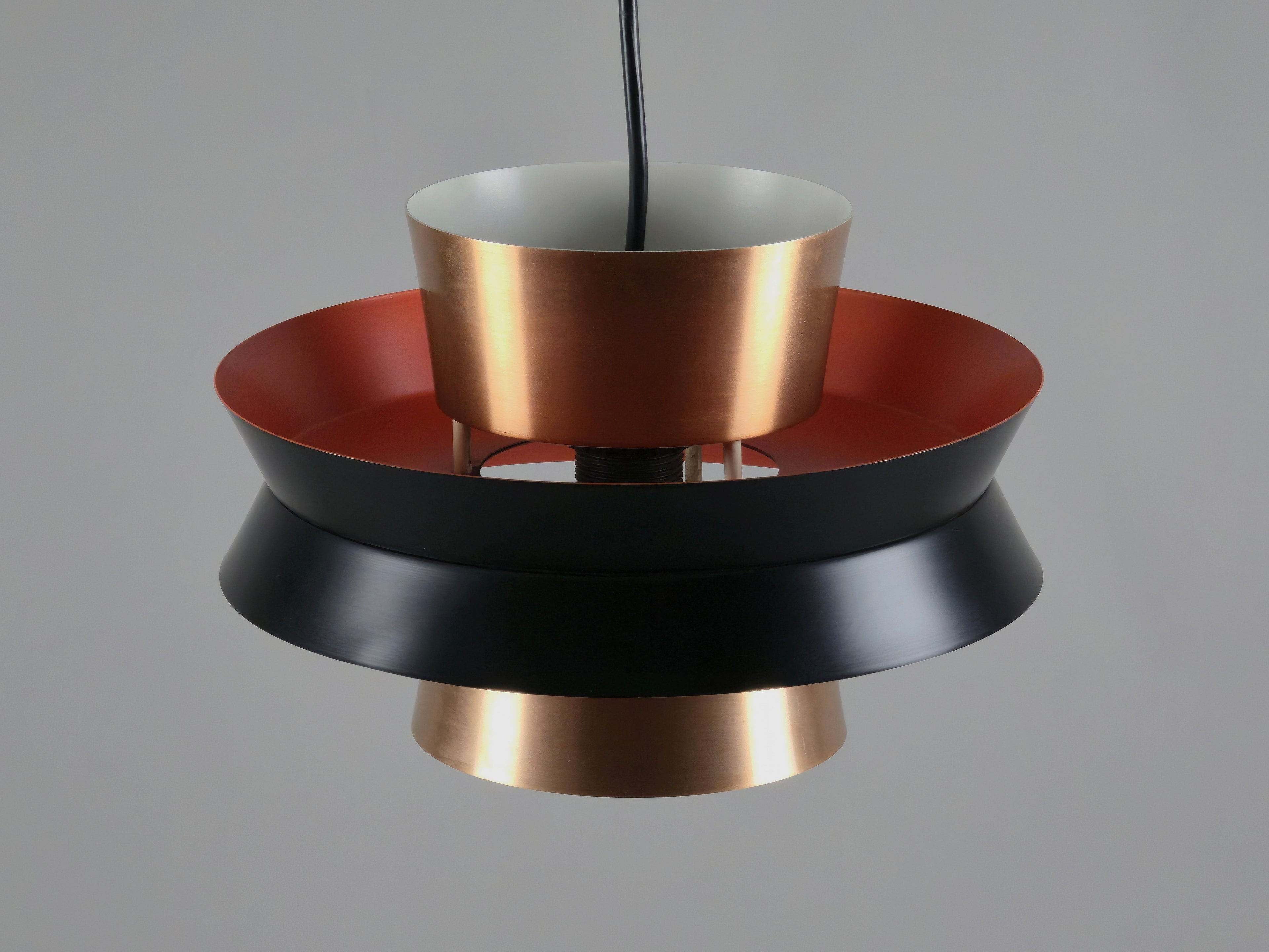 photo showing the combination of black orange and copper of the trava lamp