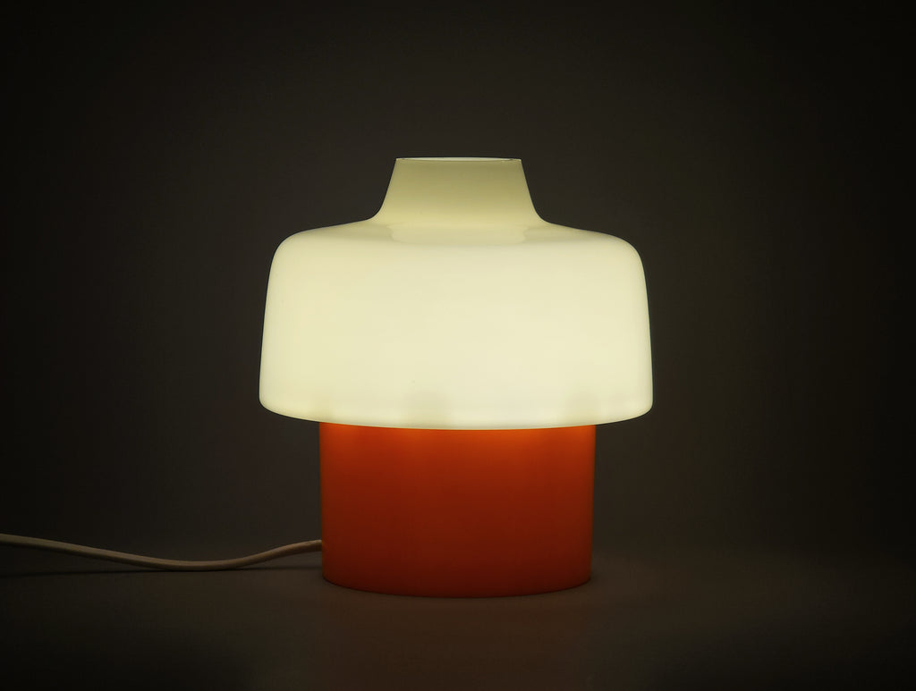 mcm bedside table lamp from the 1960 70s showing the glow of the glass shade