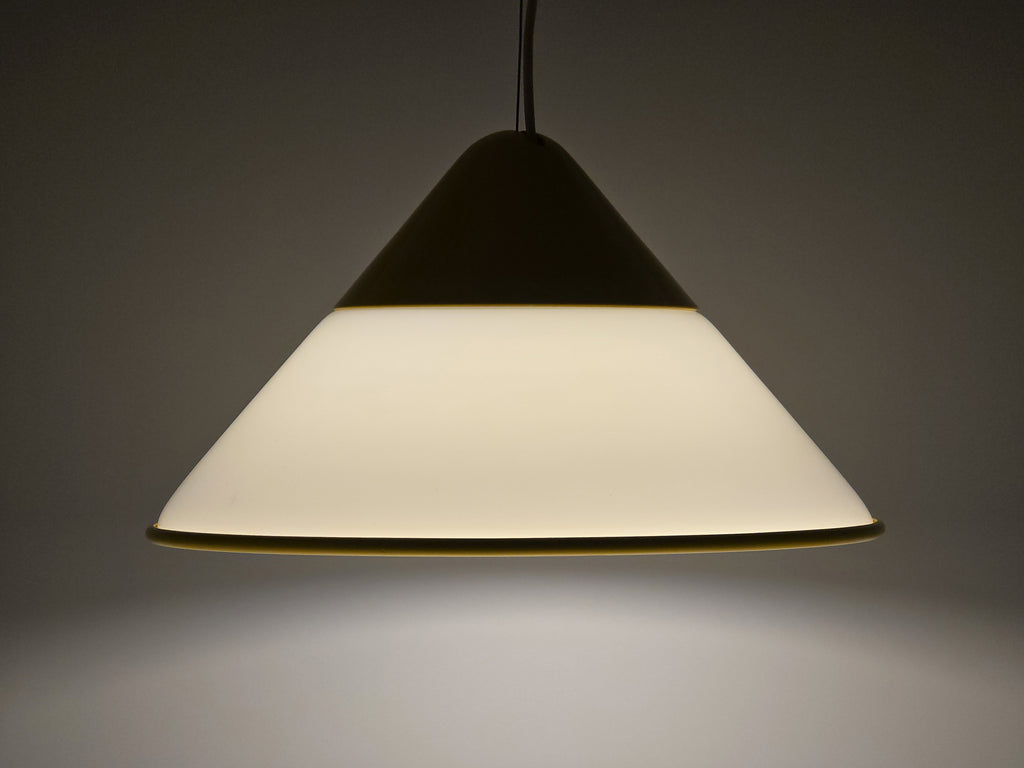 1980s Vintage Fabbian Italian opaline glass pendant lamp, Mid-Century Modern conical white opal hand-blown glass with yellow design details, showing lit full conical profile view.