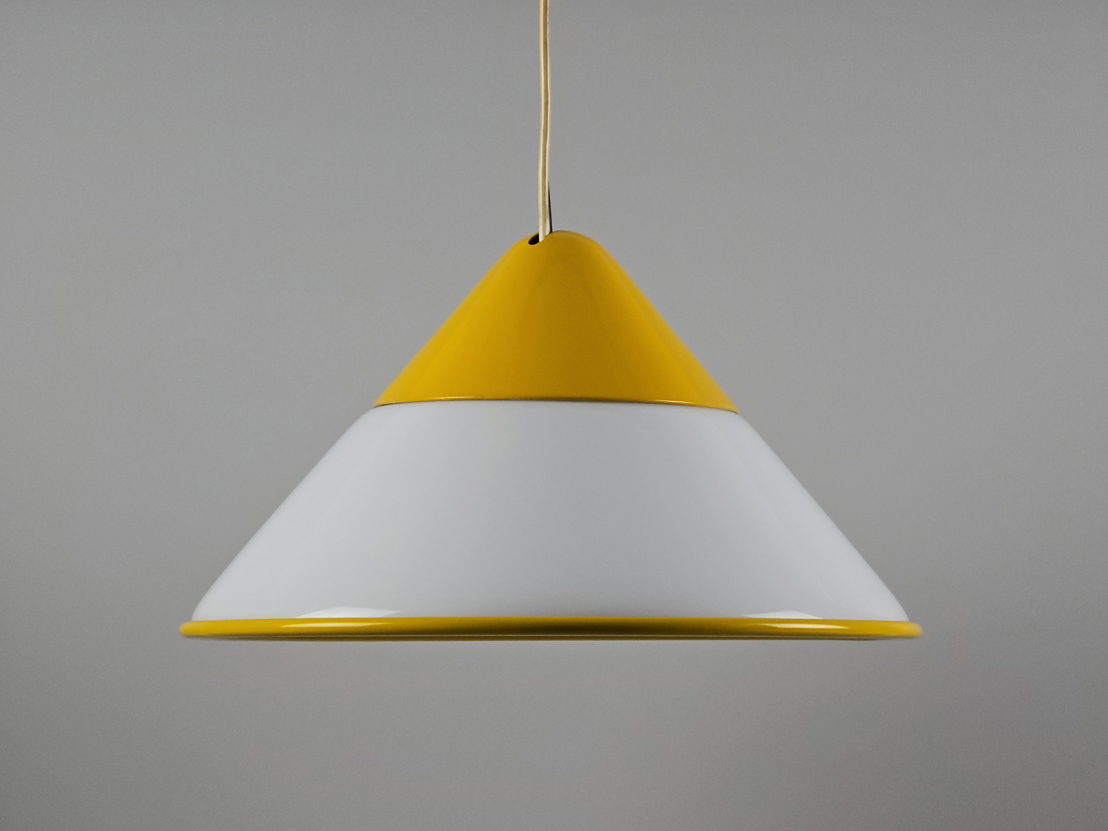 1980s Vintage Fabbian Italian opaline glass pendant lamp, Mid-Century Modern conical white opal hand-blown glass with yellow design details, profile view.