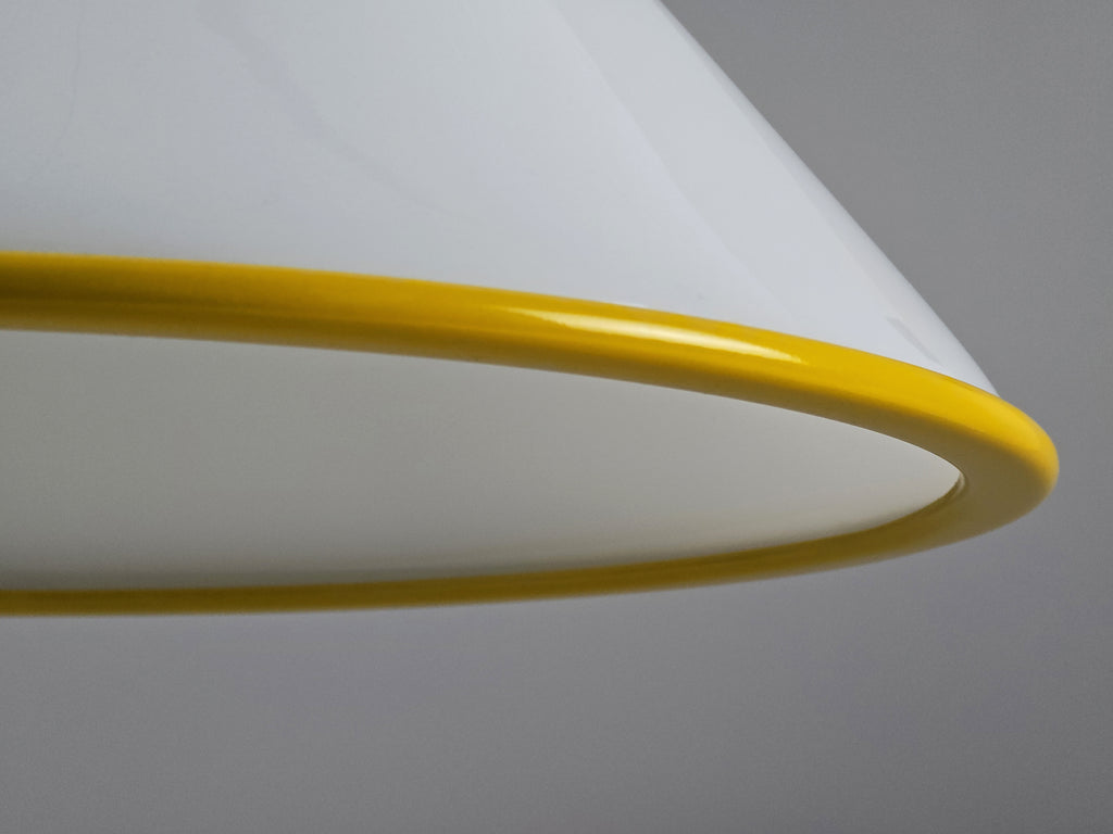 1980s Vintage Fabbian Italian opaline glass pendant lamp, Mid-Century Modern conical white opal hand-blown glass with yellow design details, showing the yellow metal border and the inner shade.