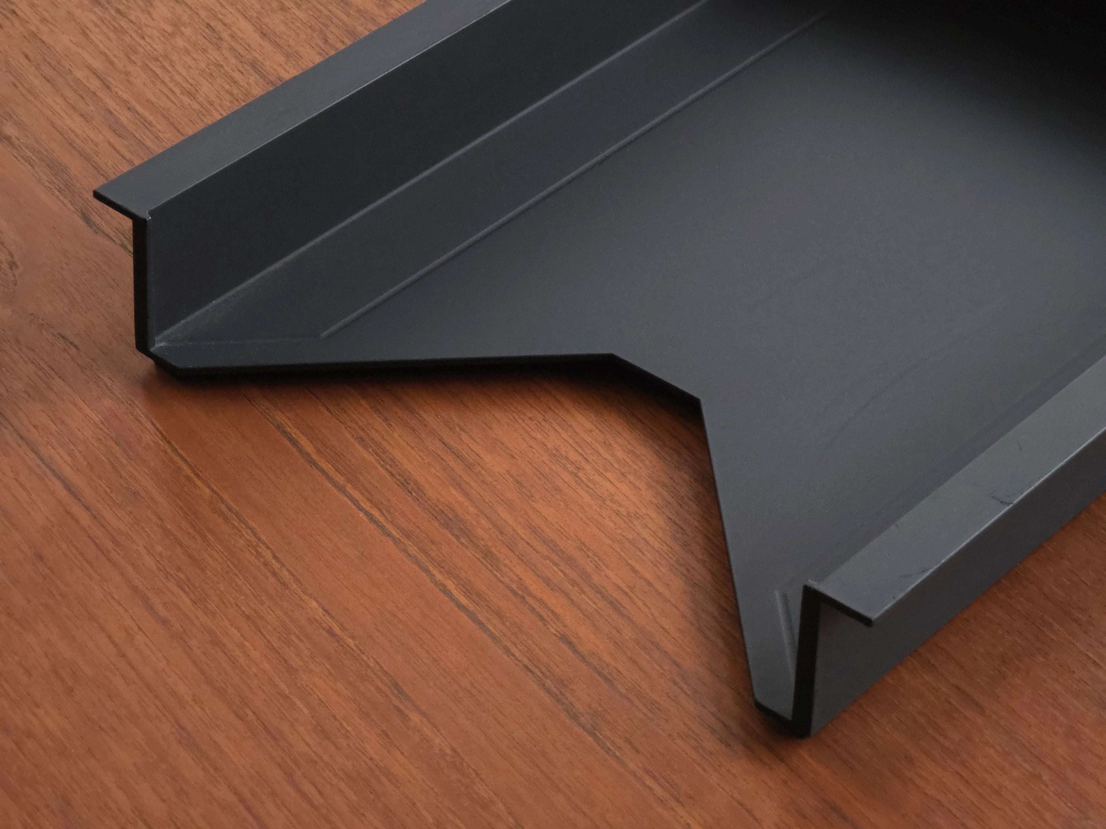 Vintage Helit document tray designed by Norman Foster, matte black soft-touch finish, close up image of the front V-shaped design.