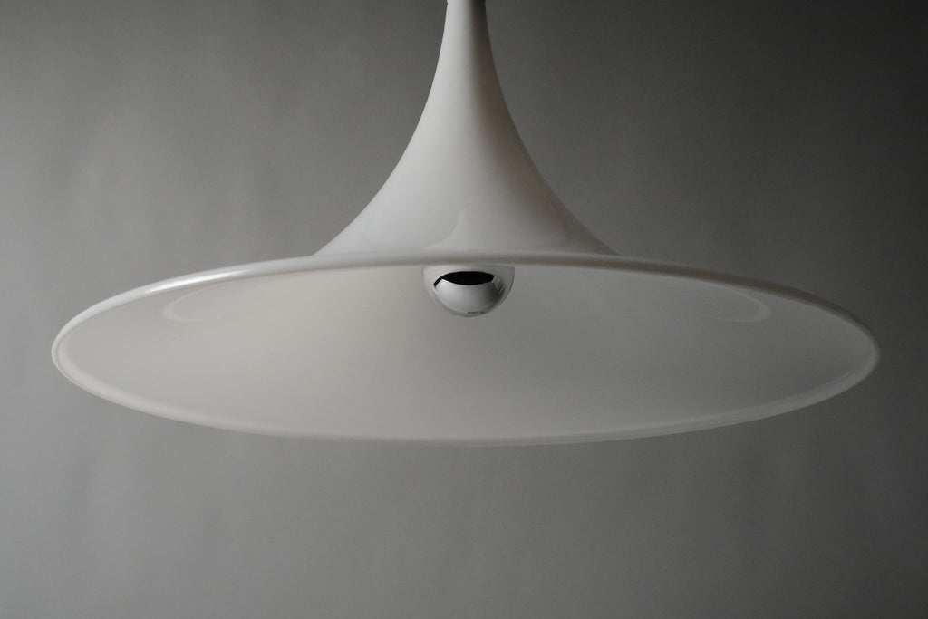 Low angle front view of the Dijkstra witch hat pendant, emphasising the dramatic swept conical form and opaline translucency