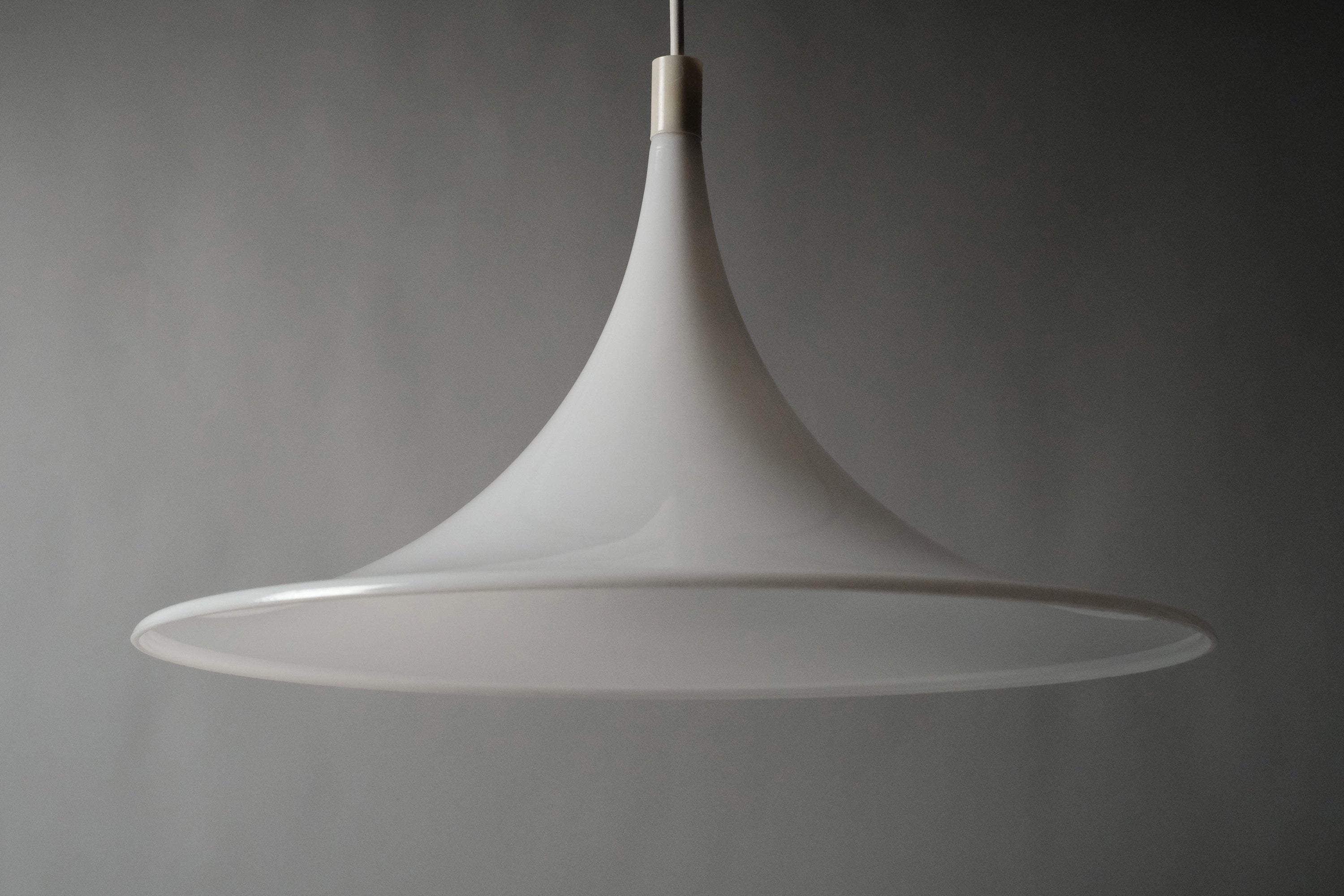 Straight-on front view of the Dijkstra Lampen witch hat pendant lamp, white opaline acrylic shade fully visible against neutral grey