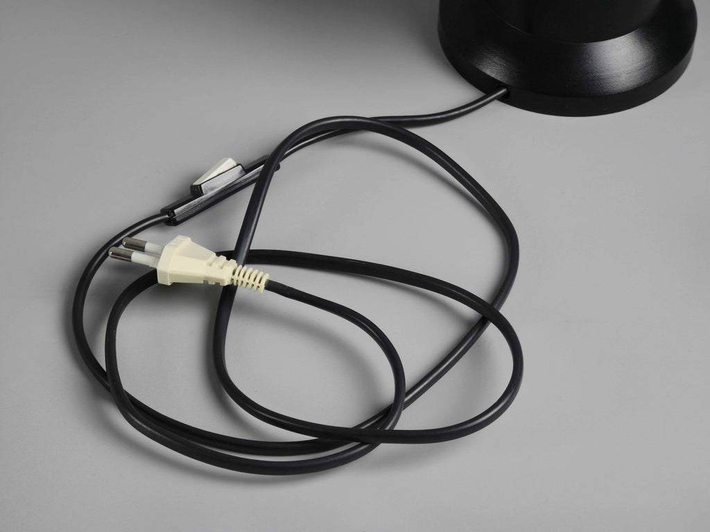 Detailed view of the cord, two-pin Euro power socket and the inline switch attached to the base of the lamp.
