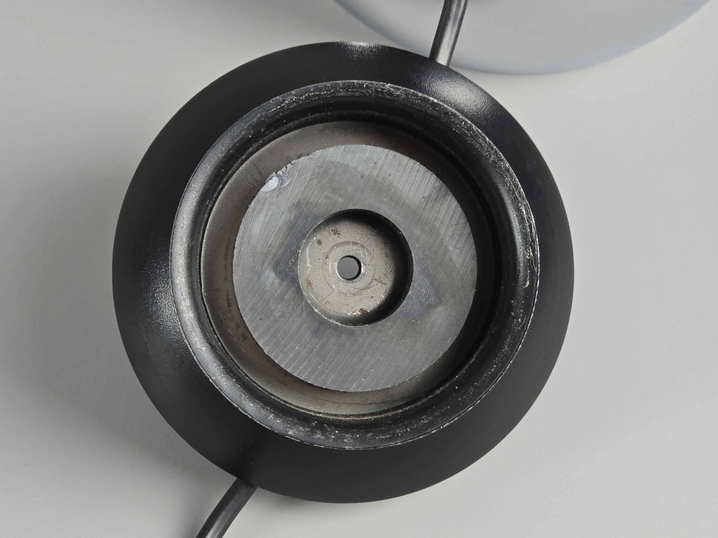 A close-up view of the strong magnet on the plastic base of the eyeball light where the shade can be attached to.