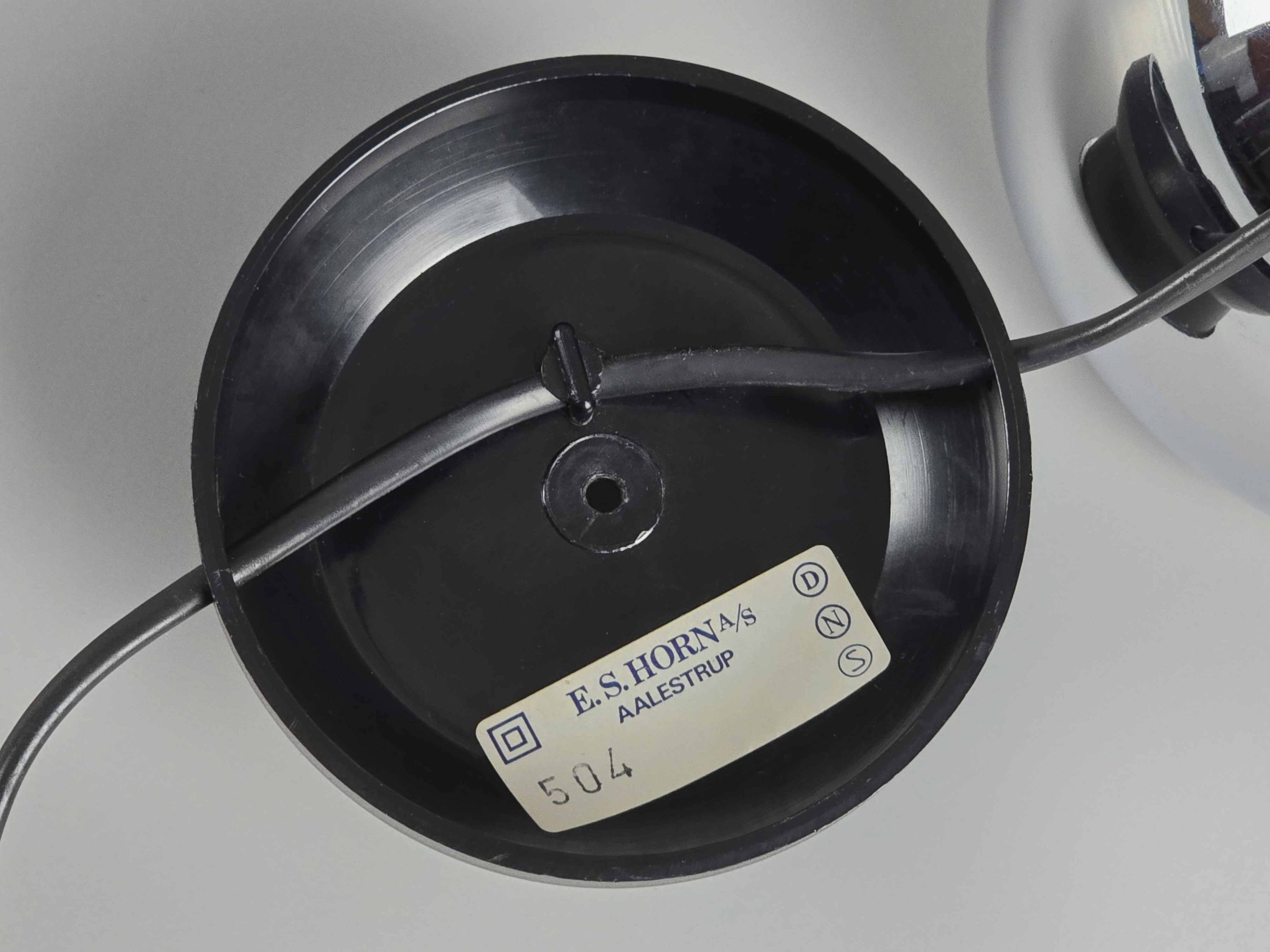A close-up detail of the authentic label which reads "E.S. HORN/S AALESTRUP" and "504". A black wire is attached to the component.