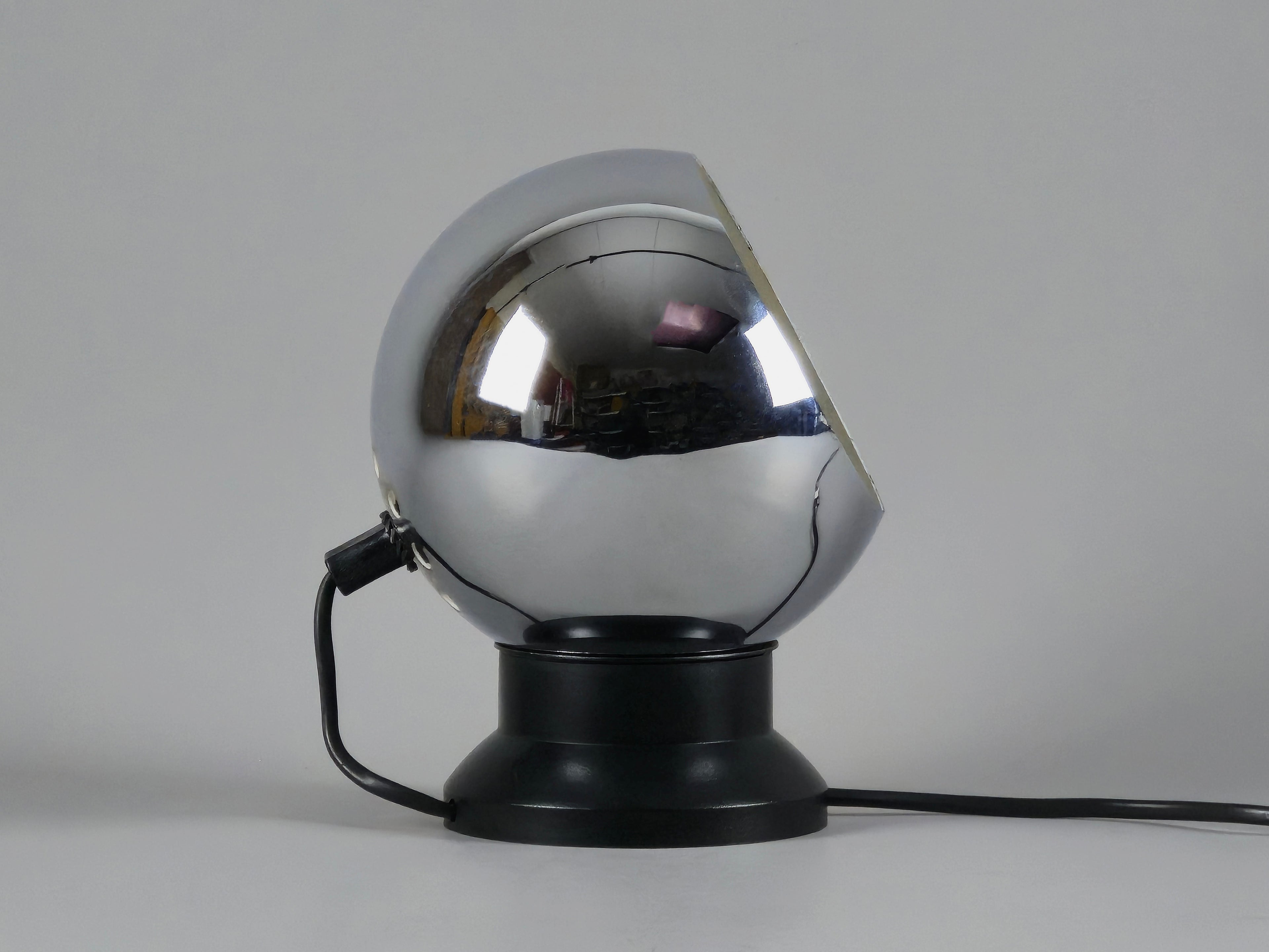 Profile of vintage E.S. Horn magnetic ball table lamp in chrome and black with neutral background.