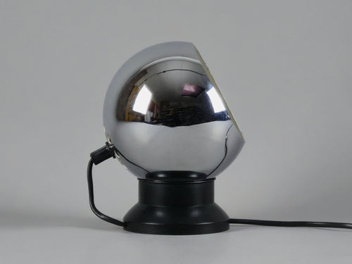 Profile of vintage E.S. Horn magnetic ball table lamp in chrome and black with neutral background.