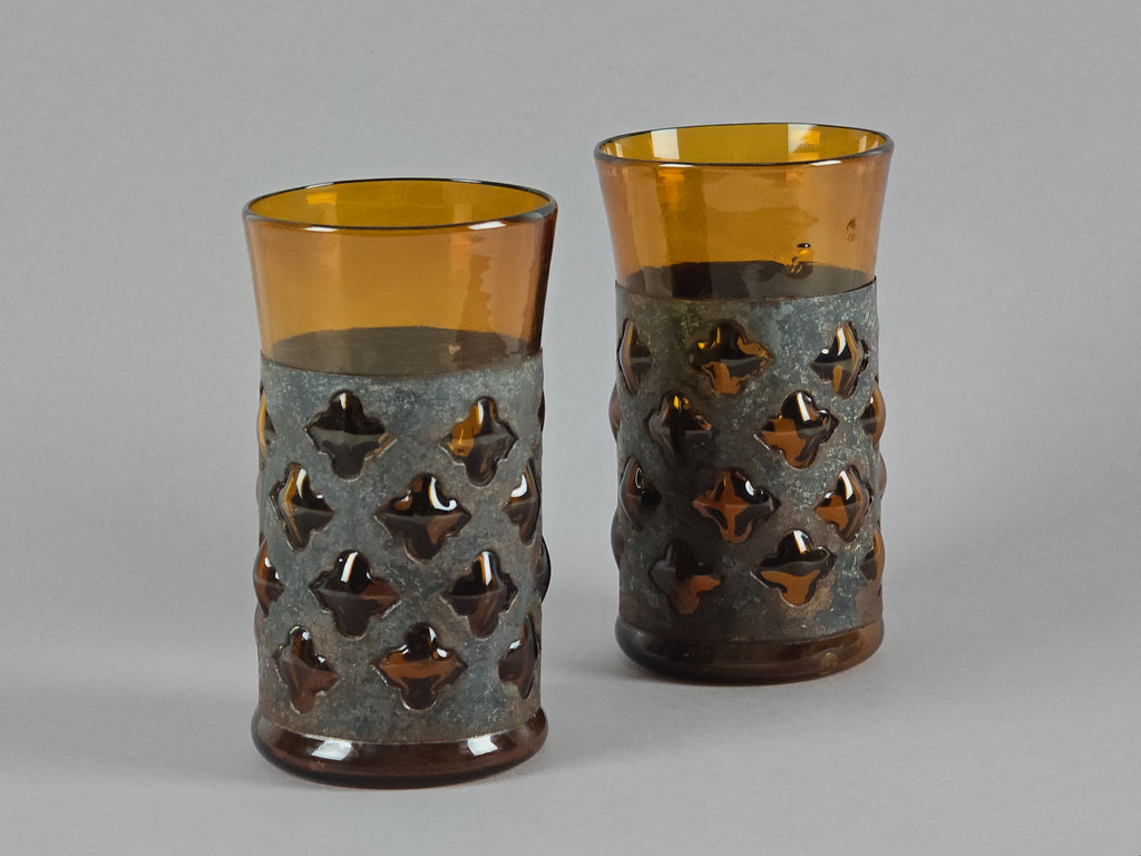 Pair of vintage Felipe Derflingher Brutalist tumblers with amber glass imprisoned in metal cages.