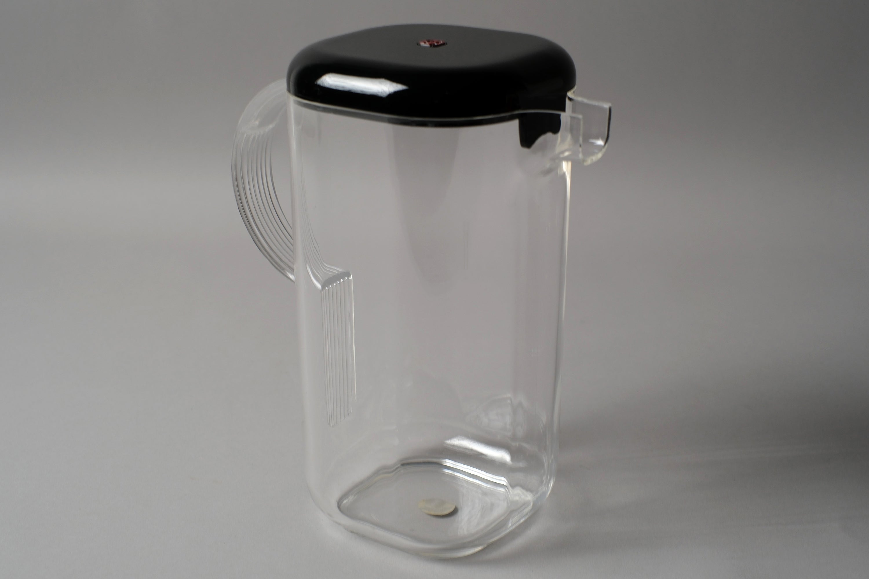 Guzzini Amanda pitcher by Ambrogio Pozzi, clear acrylic body with black lid, Italy 1970s, new old stock