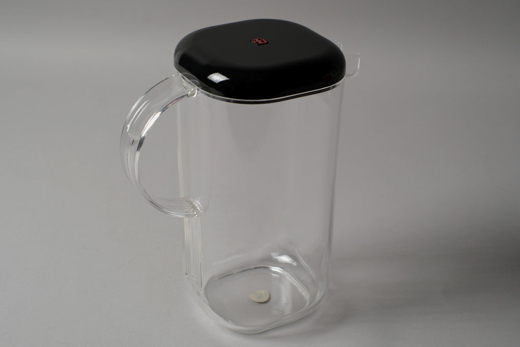 Guzzini Amanda pitcher by Ambrogio Pozzi, clear acrylic with black lid, showing handle and lid detail, Italy 1970s