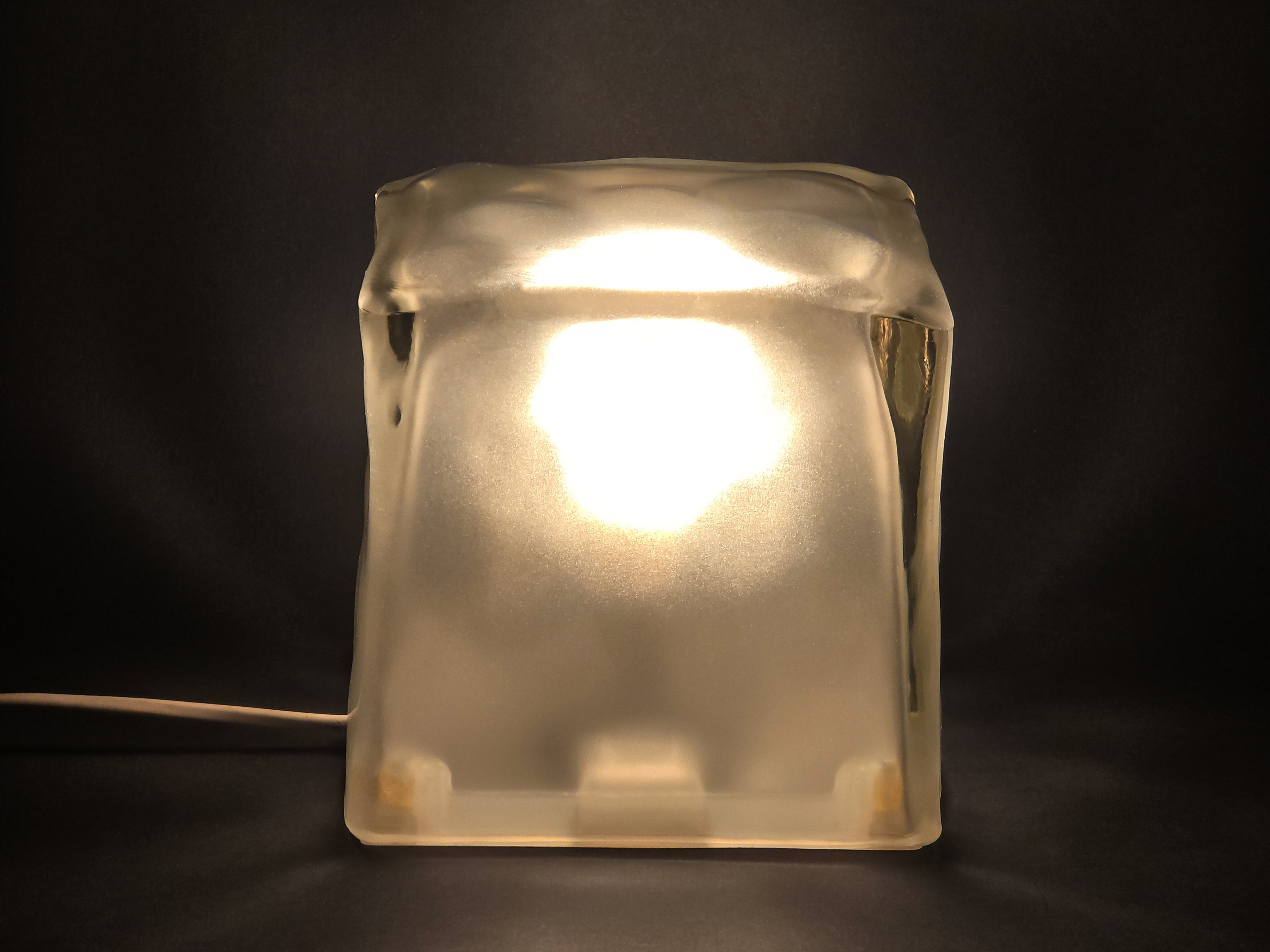 IKEA Iviken Ice Cube glass table lamp illuminated.