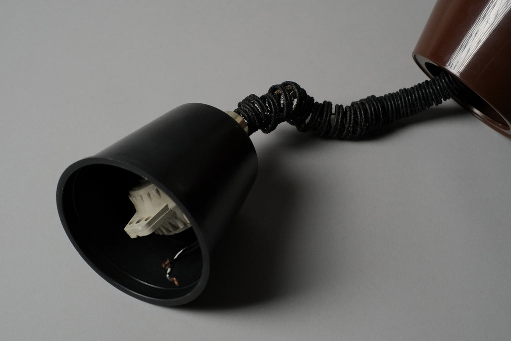 Close-up of the original ceiling cap and rise and fall rolly mechanism of a 1970s Massive Lighting Belgium UFO pendant lamp, showing the coiled cord and original hardware intact.