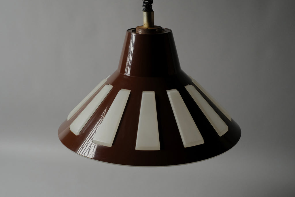 High-angle view of a 1970s Massive Lighting Belgium UFO pendant lamp unlit, showing the brown ABS outer shell with geometric cutouts and the full UFO profile from above.