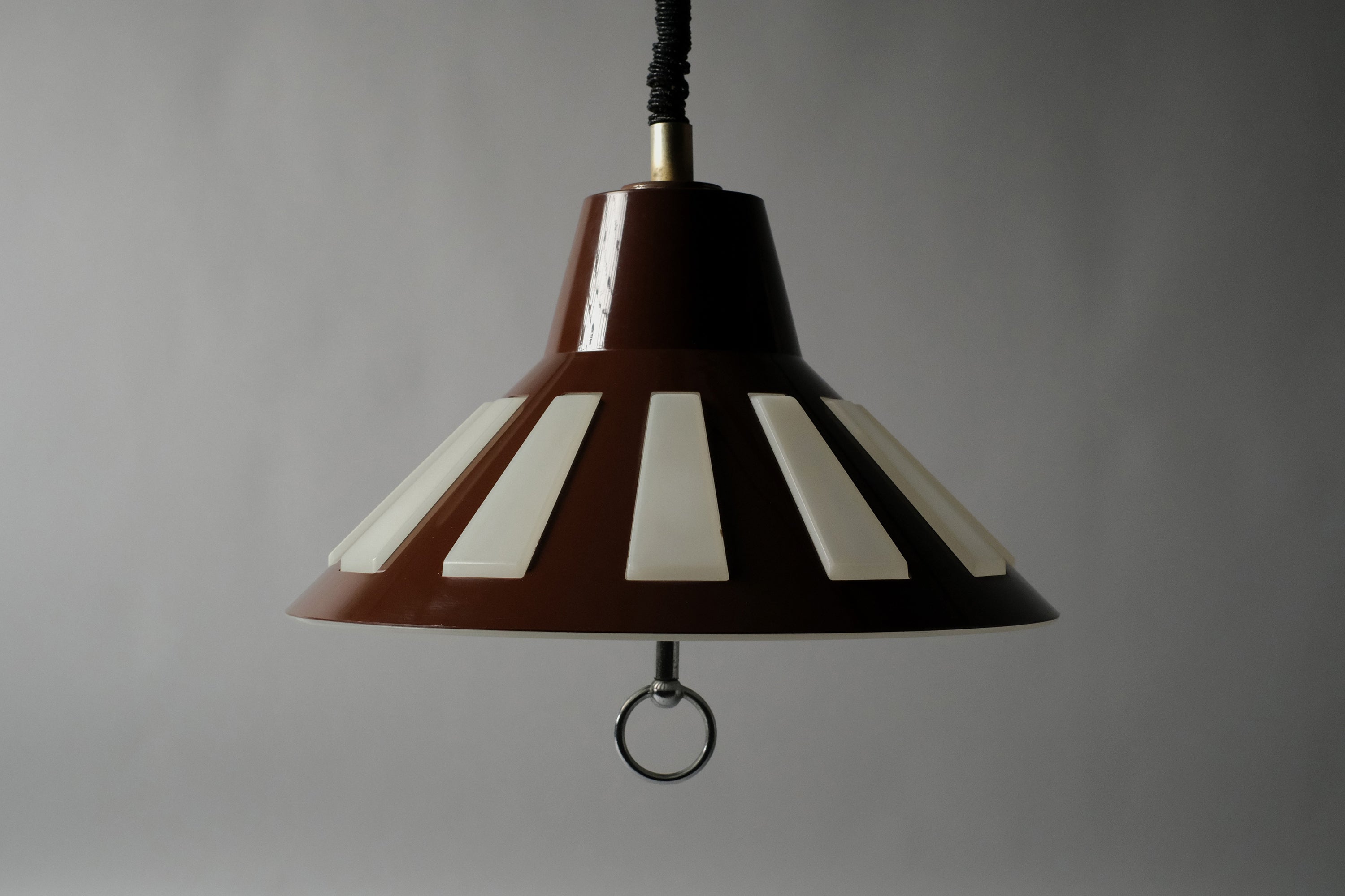 Straight front view of a 1970s Massive Lighting Belgium UFO pendant lamp unlit, showing the complete dual-layer form and original rise and fall cord against a neutral background.