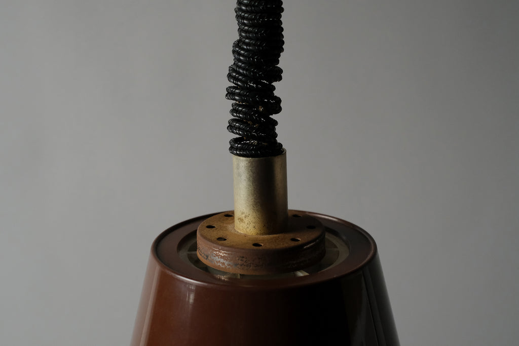 Macro detail of the central hardware assembly of a 1970s Massive Lighting Belgium UFO pendant lamp, showing the original ceiling cap connection and rise and fall mechanism components.