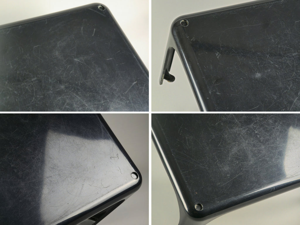 1960s MCM Artemide Milano 'Demetrio 45' black fiberglass side table by Vico Magistretti, these are four images combined into one image, to show the tear and wear of the table from different angles and under projector lighting.