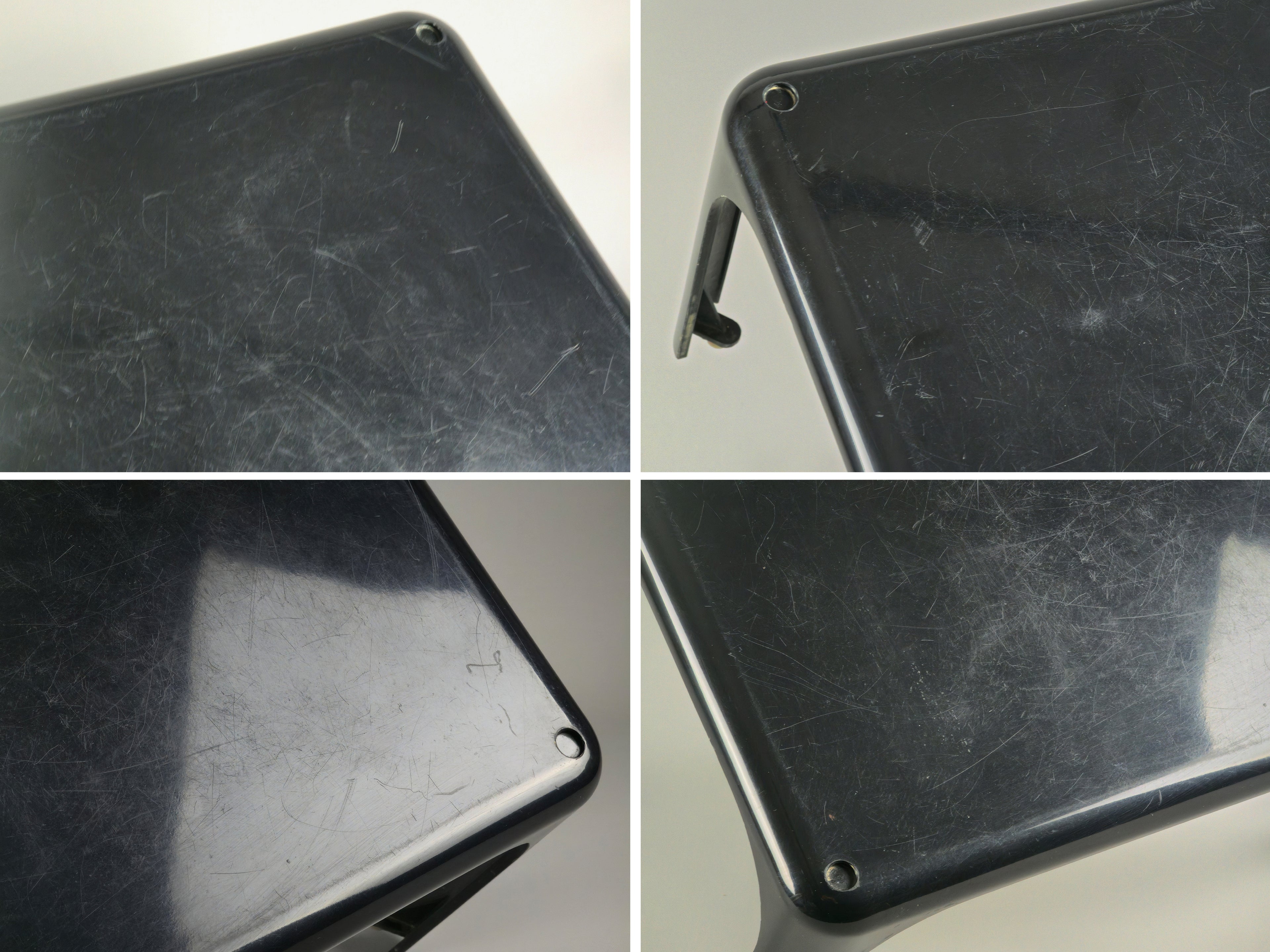 1960s MCM Artemide Milano 'Demetrio 45' black fiberglass side table by Vico Magistretti, these are four images combined into one image, to show the tear and wear of the table from different angles and under projector lighting.