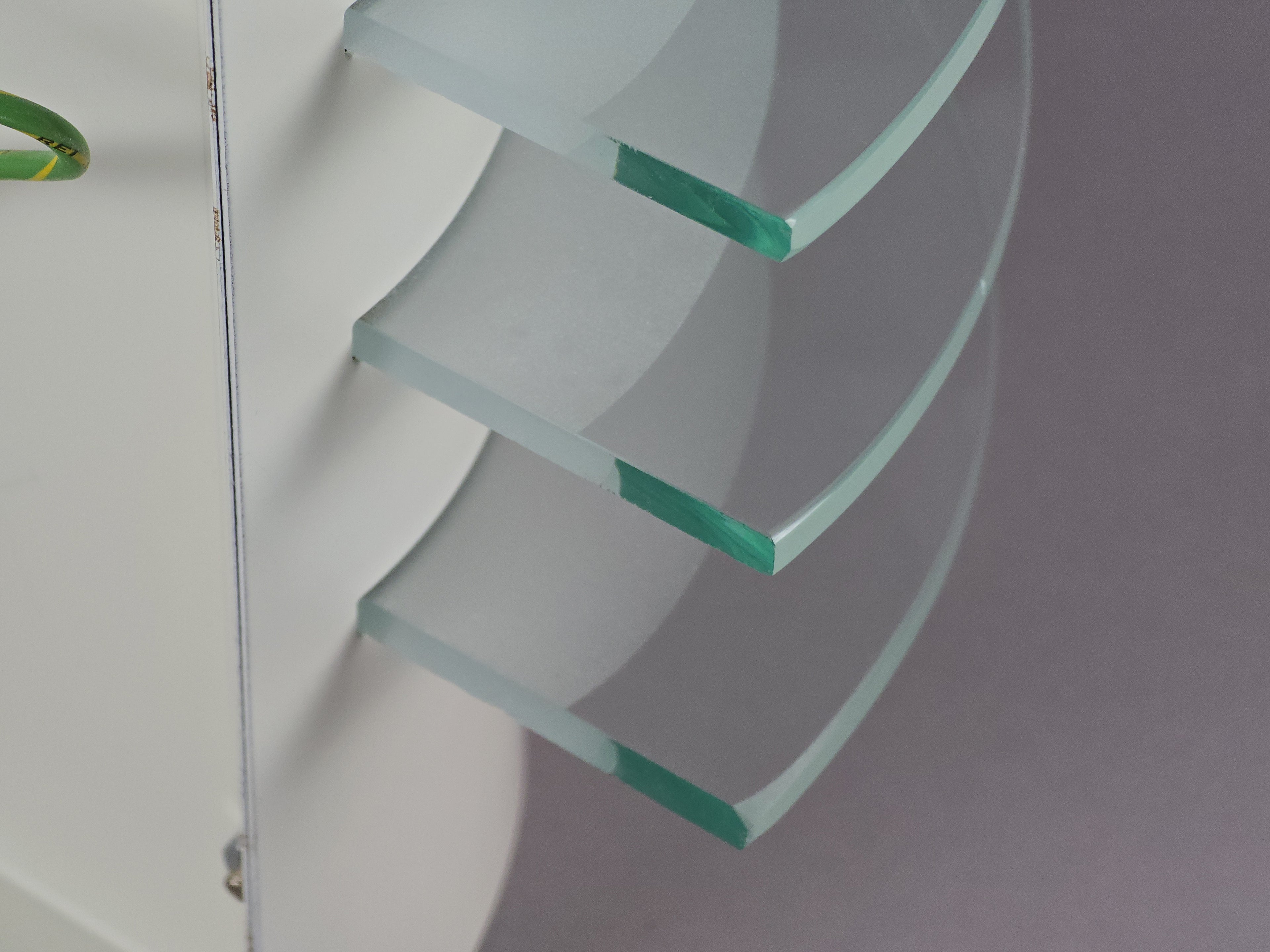 Close-up of the thick stepped glass discs of the IKEA Drittel lamp, highlighting the vintage postmodern material quality.