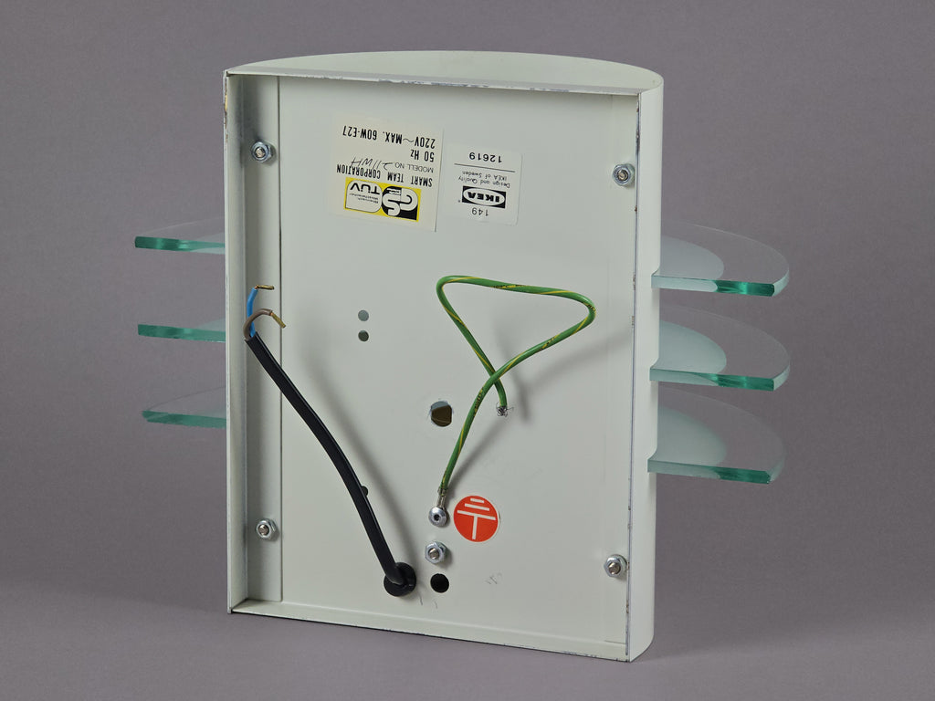 Back view of the IKEA Drittel wall lamp showing the original metal bracket for direct wall-point installation.