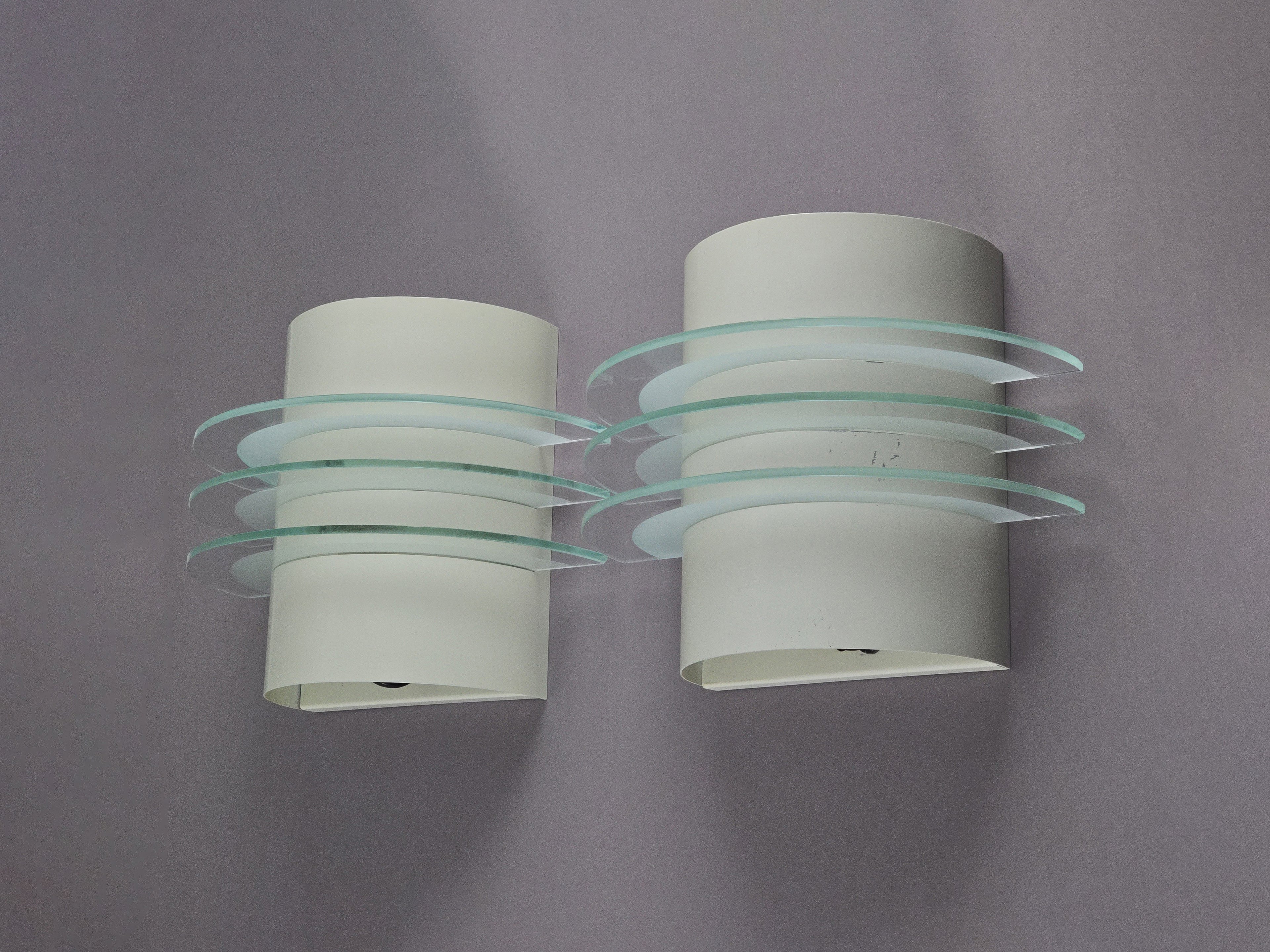 Vintage 1992 pair of IKEA Drittel wall sconces with glass discs, wall mounted on a neutral background.