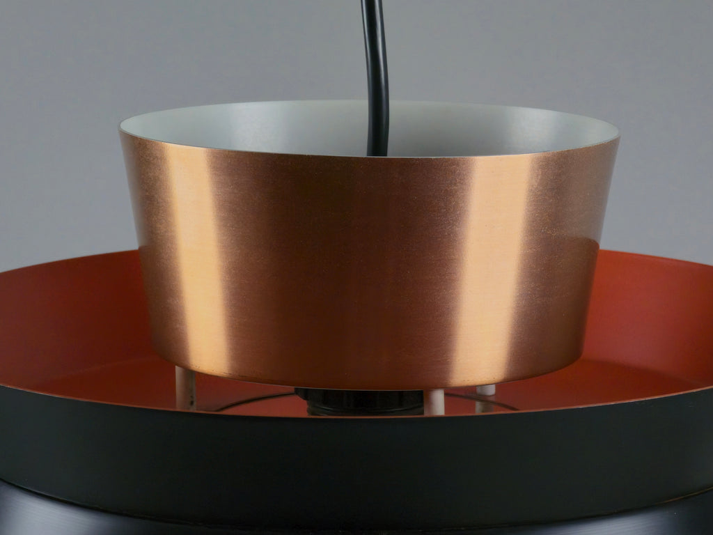 close up image showing the top copper disc of the carl thore design lamp